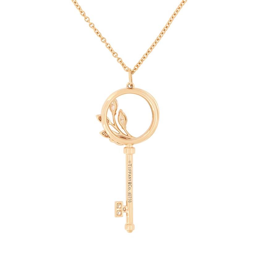 This beautiful ‘Victoria Key’ pendant comes from the designer Tiffany & Co. and features a diamond vine circle design. Three marquise cut diamonds are claw set, accompanied by a ring of grain set round brilliant cut diamonds totalling 0.44 carat.