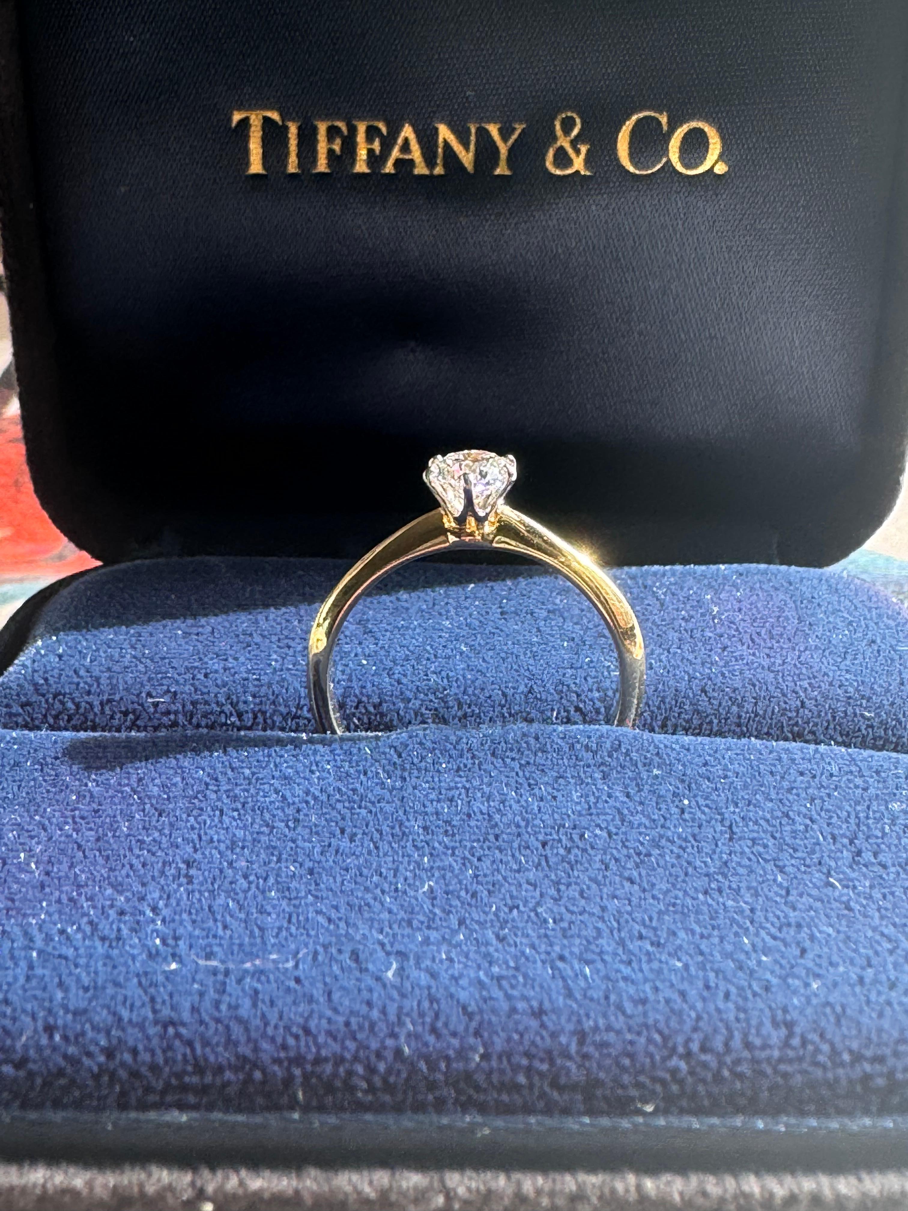 Tiffany & Co. Tiffany Setting Diamond Solitaire Ring.  Featuring a perfect round brilliant cut 0.47 carat diamond secured by 6 prongs set in 18K gold. 

Condition Description: 
In excellent condition, no scratches or marks, comes with the original