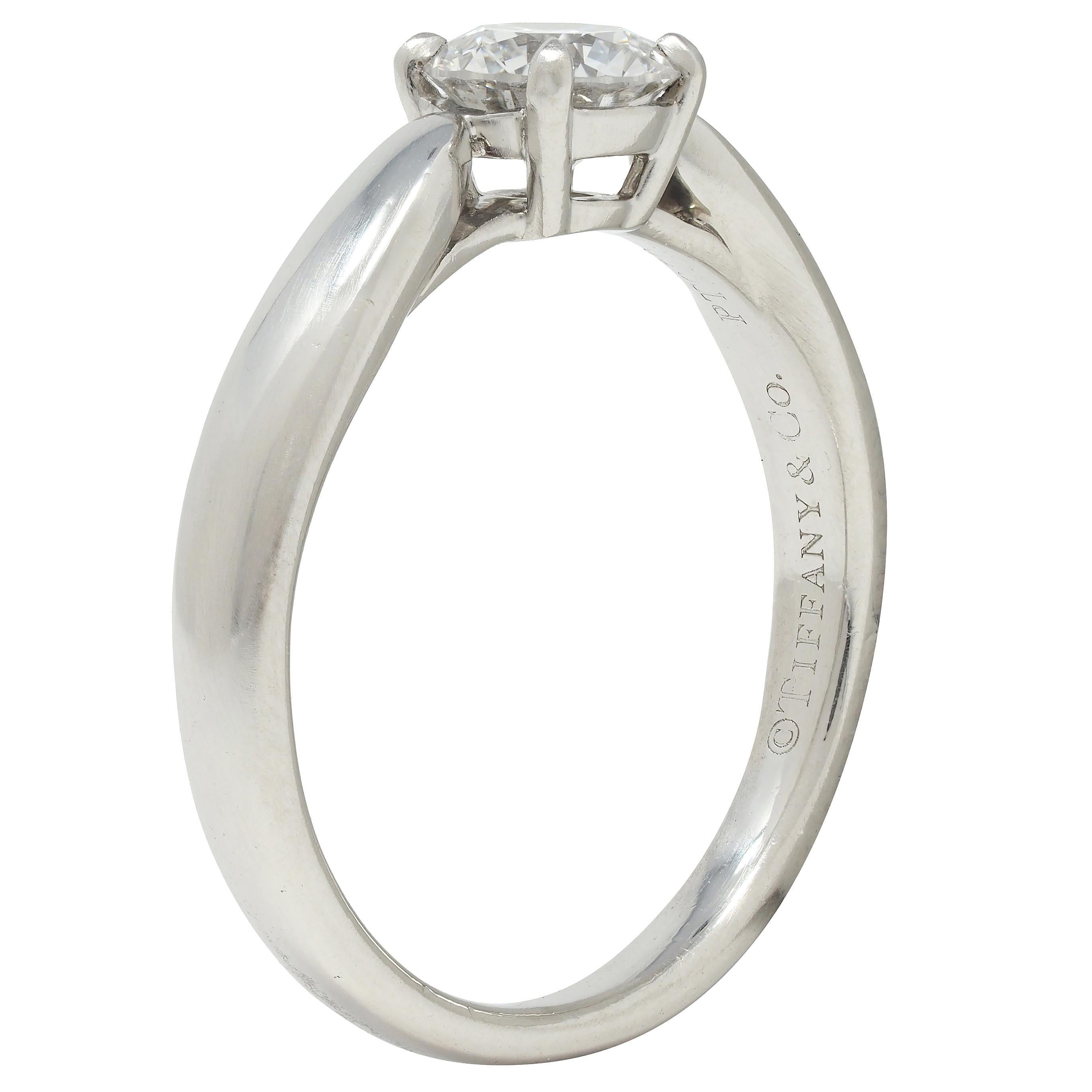 Centering a round brilliant cut diamond weighing 0.48 carat - F color with VVS1 clarity
Prong set in basket and flanked by tapered shoulders
With high polish finish and inscribed with carat weight
Stamped for platinum 
Numbered and fully signed for