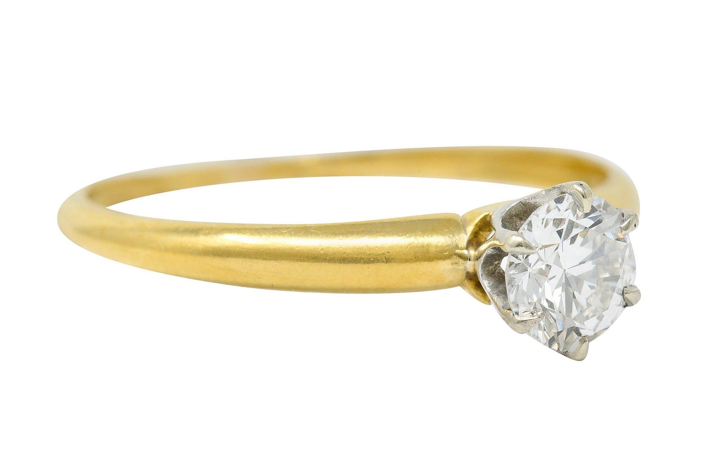 Solitaire ring centers a round brilliant cut diamond weighing approximately 0.50 carat - H color with VS clarity

Talon set by six prongs in a platinum head

Completed by a polished gold 18 karat gold shank

Stamped for platinum and 18 karat