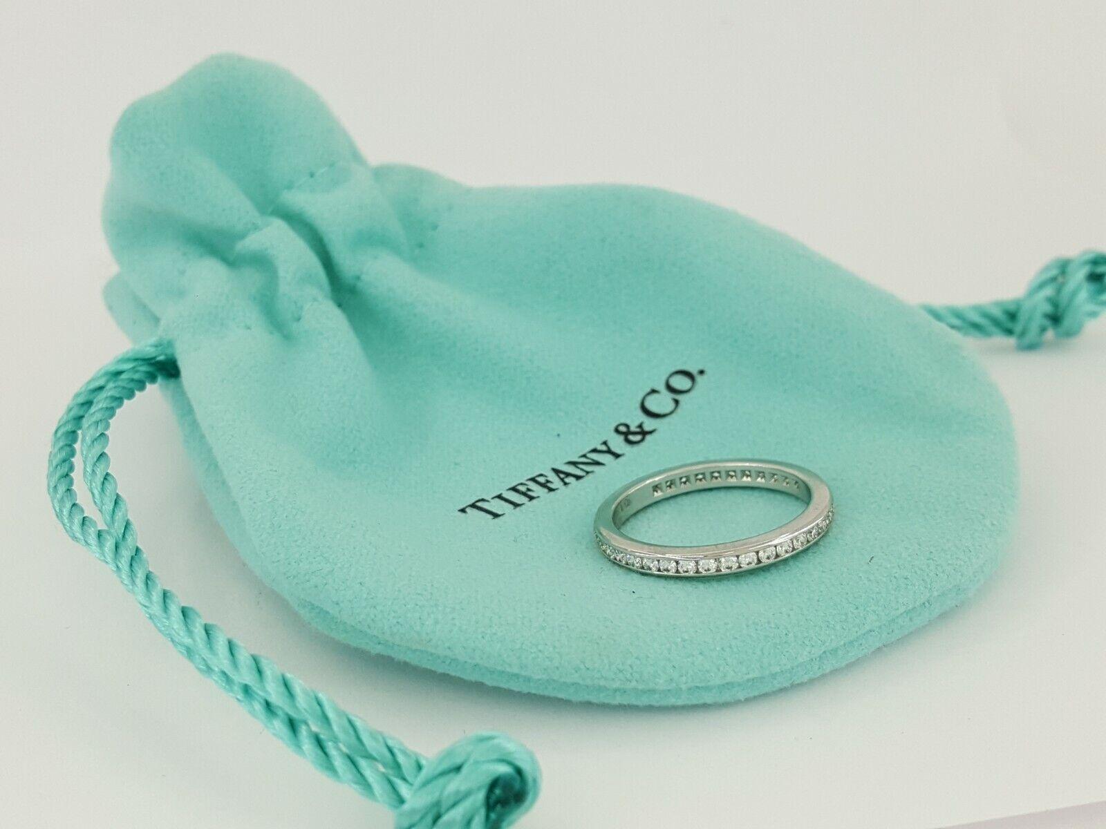 Experience the timeless elegance of this stunning Tiffany & Co. eternity band ring, a symbol of everlasting love and commitment. Crafted with precision in solid platinum, this exquisite ring features a continuous circle of sparkling diamonds