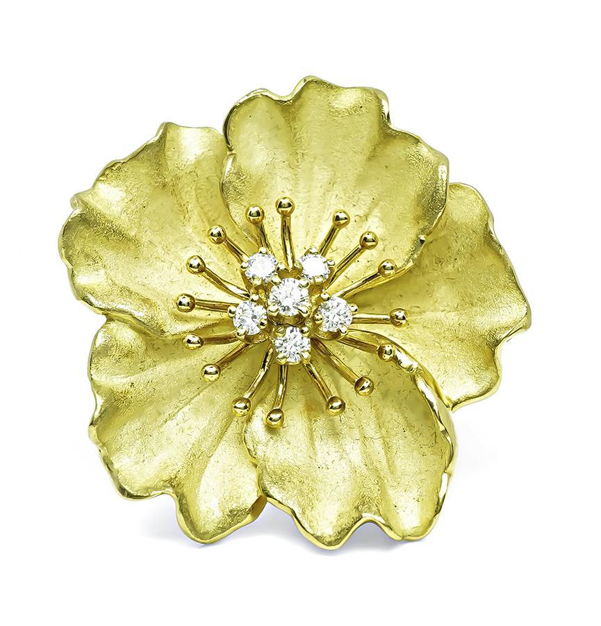 This is an elegant 18k yellow gold pin by Tiffany & Co. The pin is set with sparkling round cut diamonds that weigh approximately 0.50ct. The color of these diamonds is E with VS clarity. The pin measures 36mm by 34mm and weighs 25.4 grams. The