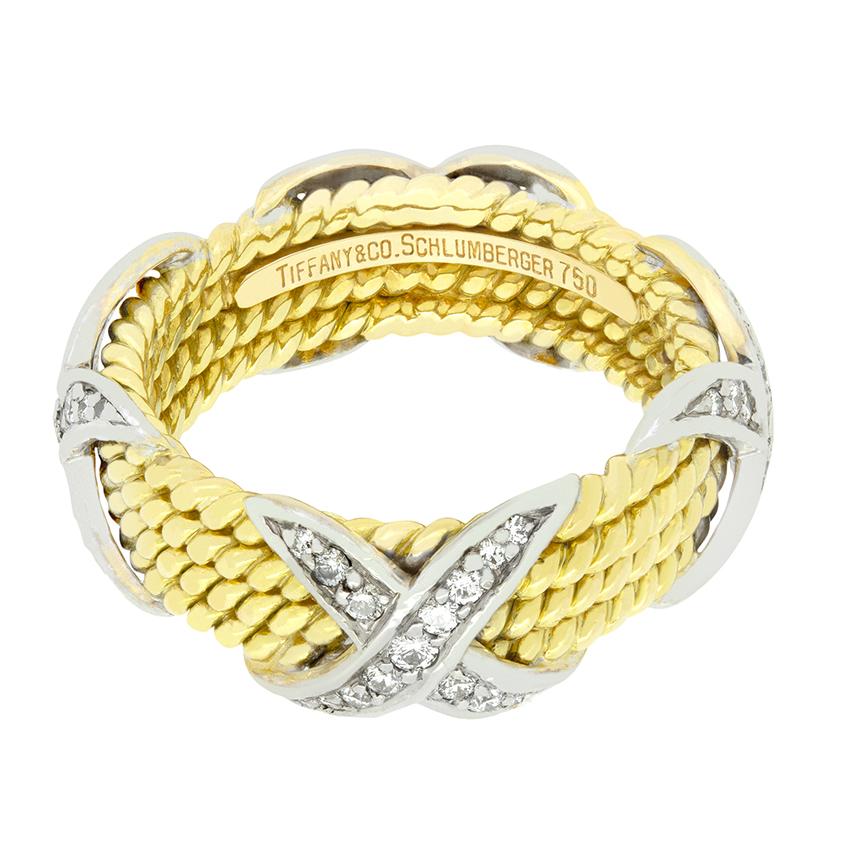 From the designer Tiffany & Co. comes this rope style ring from their ‘Schlumberger’ collection. Crafted in 18 carat yellow gold, for rows of rope envelope the finger, with the iconic Shlumberger X design sat at the cardinal points. These four X’s