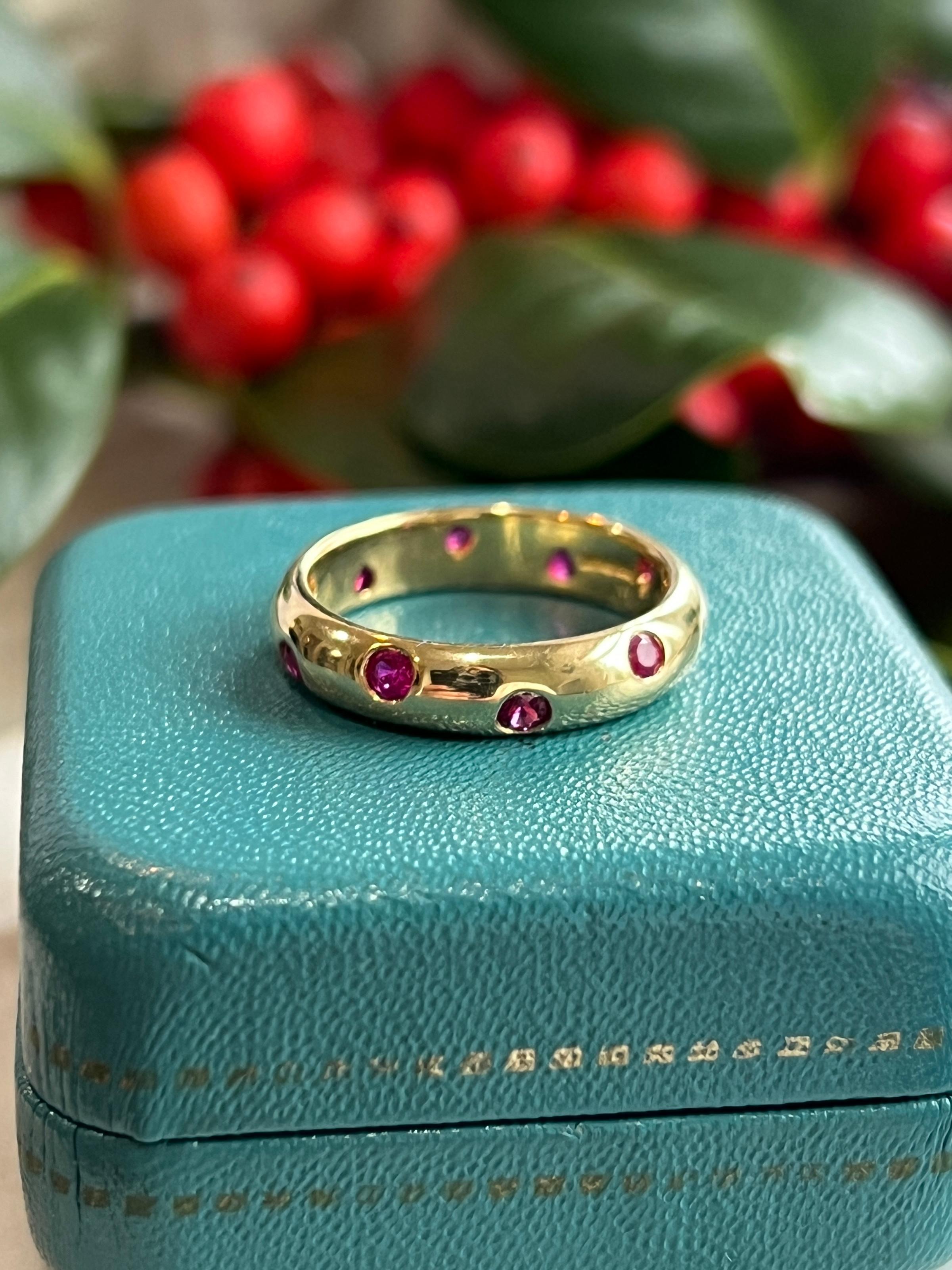 Celebrate with this stunning Tiffany & Co. Etoile ring, a masterpiece in 18-karat yellow gold. This ring dazzles with approximately 0.60 total carats of ten radiant round flush set rubies. A perfect gift for those who appreciate the artistry of one