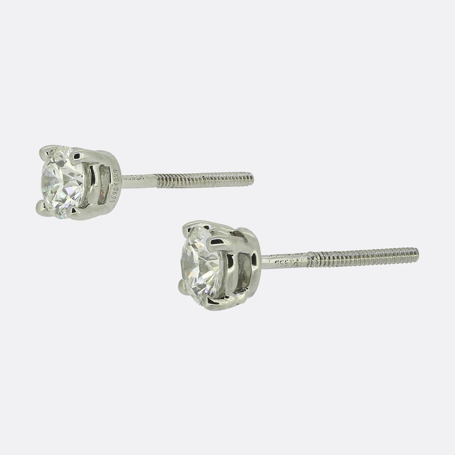 Here we have a refined pair of diamond stud earrings from the world renowned jewellery designer, Tiffany & Co. Each identical piece features a single bright white round brilliant-cut diamond, expertly set in a classic four-pronged platinum setting.