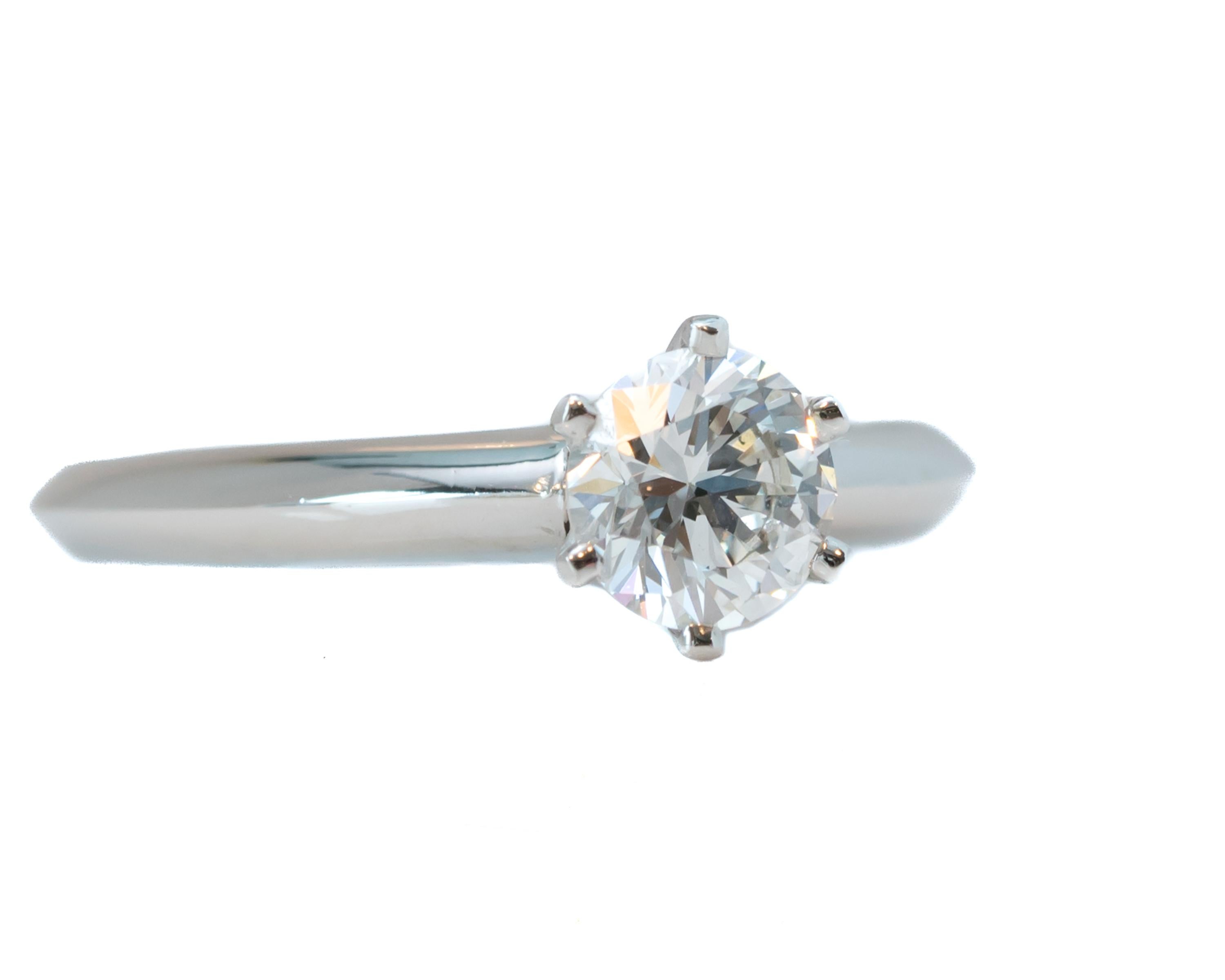 Give your loved one an irresistible ring with a Tiffany blue box.
This Tiffany and Co. engagement ring is GIA certified and has remained flawless since day one. 
This is a pristine diamond set in a high polish platinum ring.  

The band is a