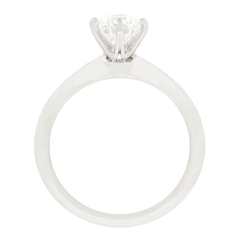 This iconic knife edge solitaire from Tiffany & Co. features a stunning 0.74 carat round brilliant diamond at its heart. The Diamond has been graded H in colour and VS2 in clarity. The band is crafted in platinum with all the original Tiffany & Co.