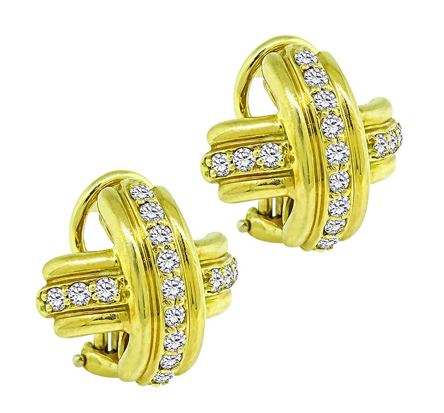 This is a stunning pair of 18k yellow gold earrings by Tiffany & Co. The earrings feature sparkling round cut diamonds that weigh approximately 0.90ct. The color of the diamonds is E with VVS clarity. The earrings measure 16mm by 16mm and weigh 10.9