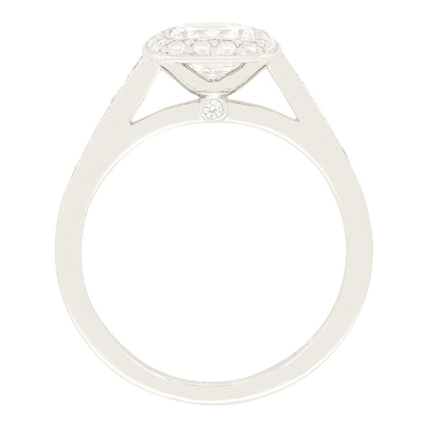 From Tiffany & Co.’s Legacy collection, this elegant Diamond Halo Engagement Ring showcases a stunning 0.91 carat cushion modified brilliant cut diamond at it’s centre. Graded F in colour and VS1 in clarity, the diamond has been rub over set.