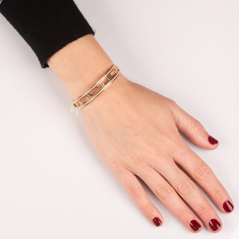 A beautiful and classic bracelet from the Atlas collection crafted of 18 karat rose gold and features the Atlas Roman numerals set with 0.92ctw round diamonds with a hinged band. This will fit up to a 6