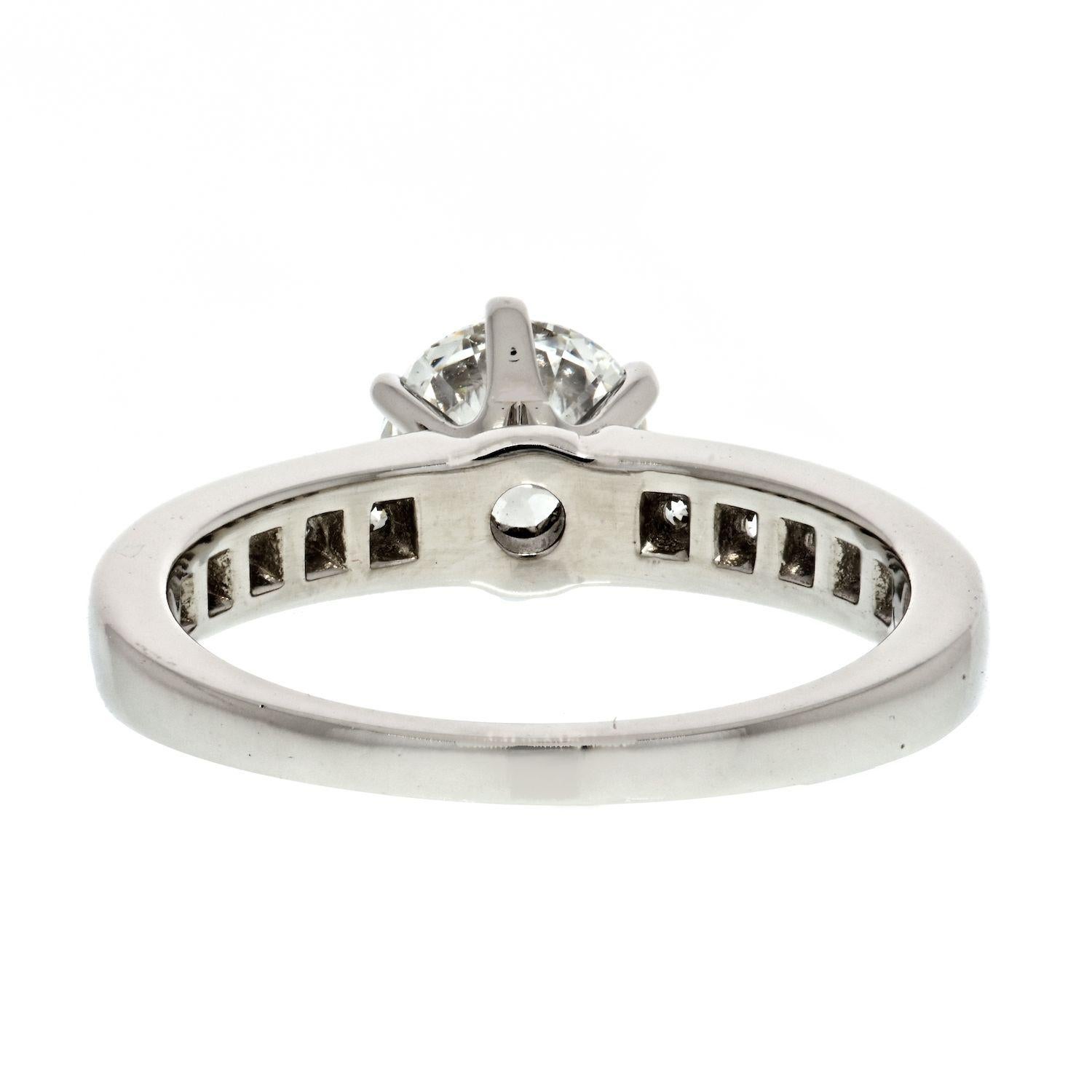 This is original Tiffany & Co. 0.99ct Round Cut H VVS1 Six Prong Diamond Engagement Ring. Mounted in platinum this ring features a round center diamond, accented with channel set diamonds on the sides.
This ring comes with it's original Tiffany & Co
