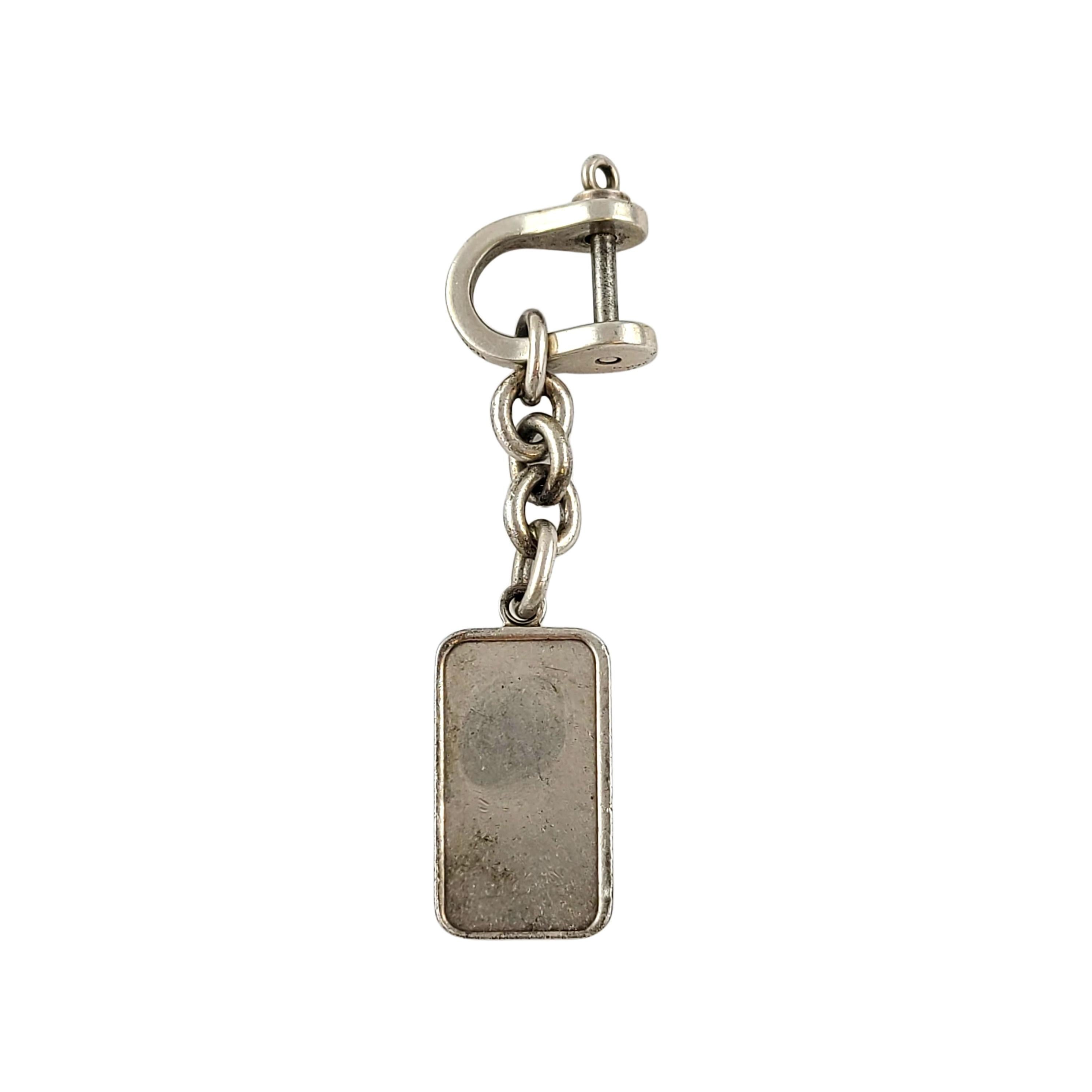 Tiffany & Co sterling silver keychain with 1/2 troy oz .999 silver ingot.

This classic sterling silver keychain is in a horsebit shape which unscrews to open to add keys. It features a 1/2 troy oz .999 silver ingot with a vintage T&CO logo. Tiffany