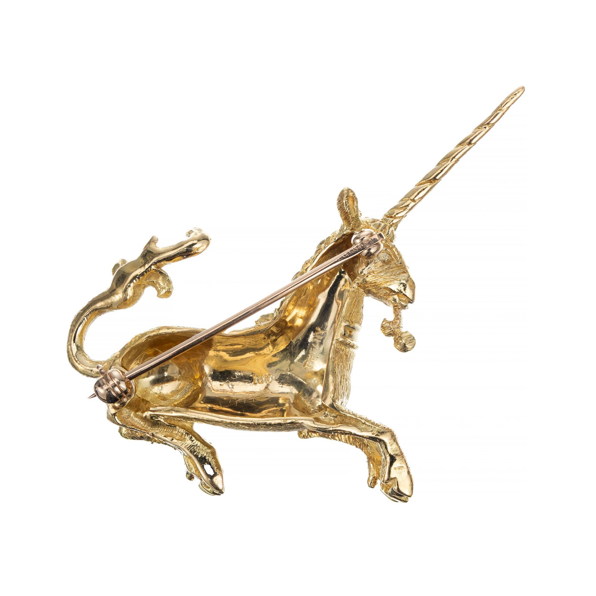 Vintage 1970's Tiffany & Co. rare unicorn brooch. Crafted in solid textured 18k yellow gold this beautiful design is accented with one round cut ruby. Highly detailed with the excellent workmanship of Tiffany's. 

1 round red ruby, approx. .1ct
18k