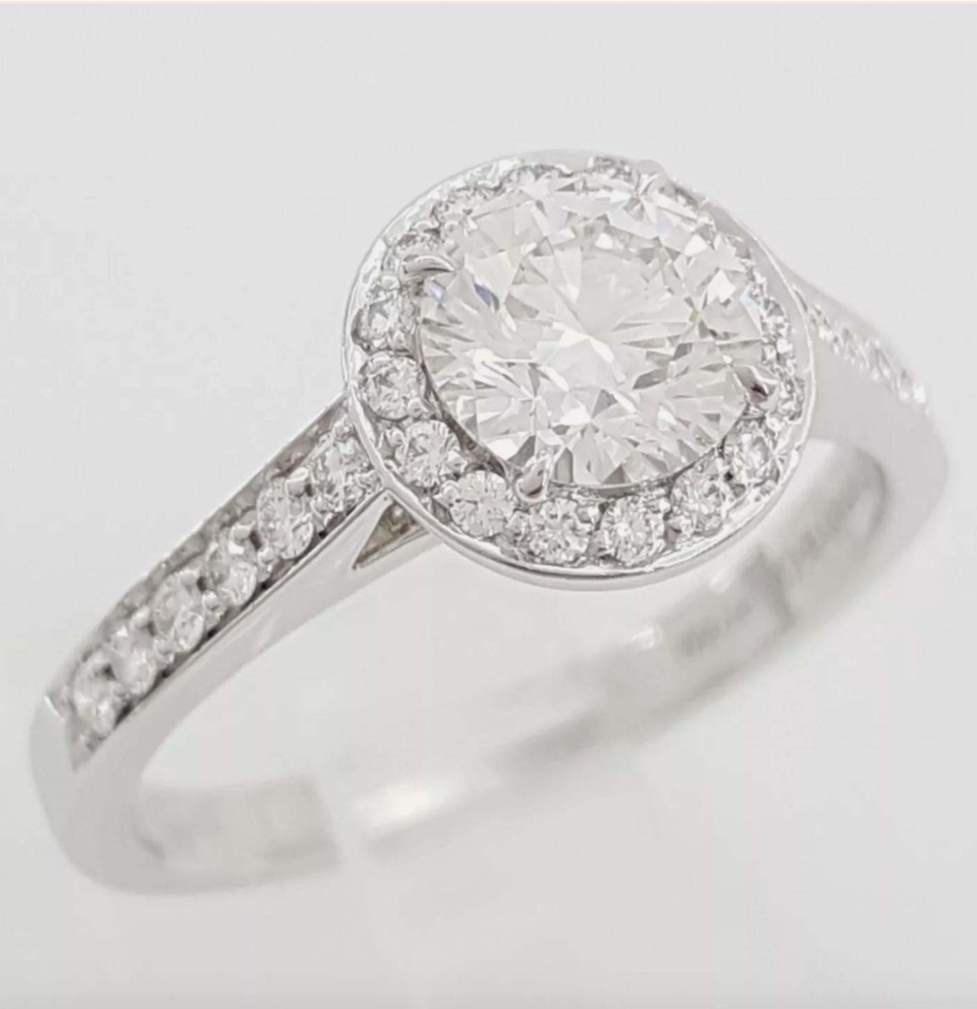 Diamond cut: Round Brilliant 
Carat: 0.75 carat
Measurements: 5.81-5.86 x 3.64 mm
Color: F
Clarity: VVS2
Fluorescence: None

Small Diamonds
Carat: 0.25 carat total
Color: D-G
Clarity: VVS-VS

Metal: Platinum
Ring size: 5.25
Stamp: TIFFANY&CO. PT950