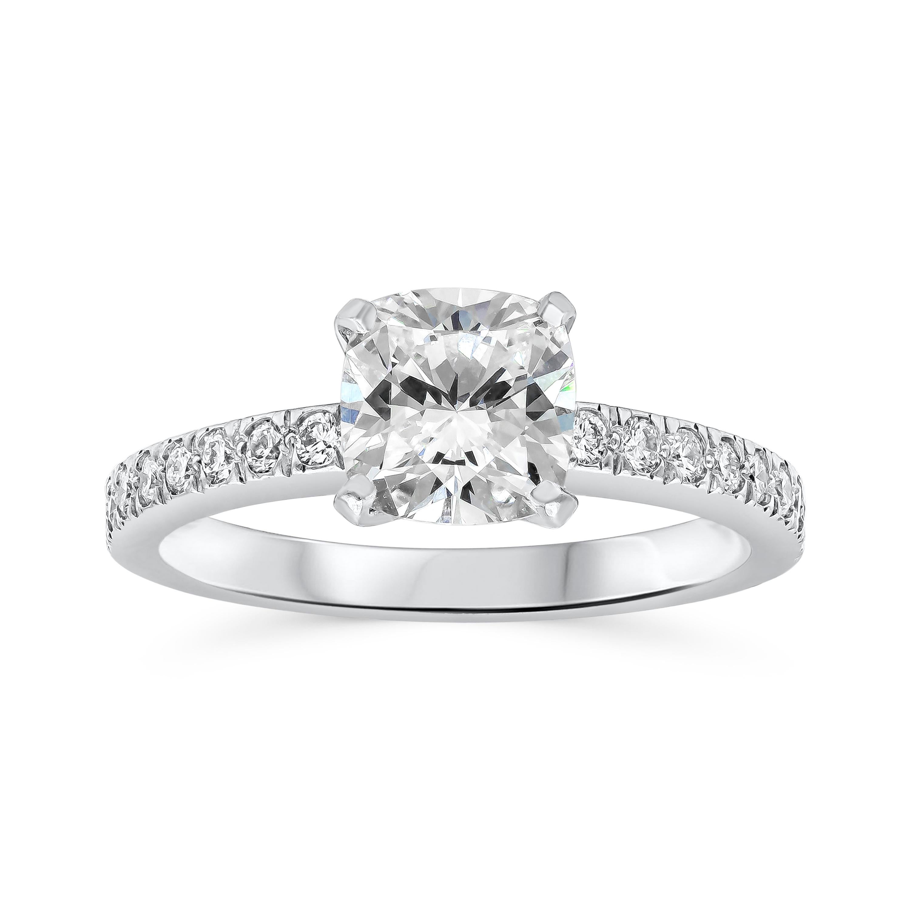 This ring features a 1.01 carat cushion cut diamond, H Color and VS1 in Clarity. Accented by a row of  round brilliant diamonds set half way down the band weighing 0.16 carats total. 
The wedding band is eternity set with round brilliant diamonds