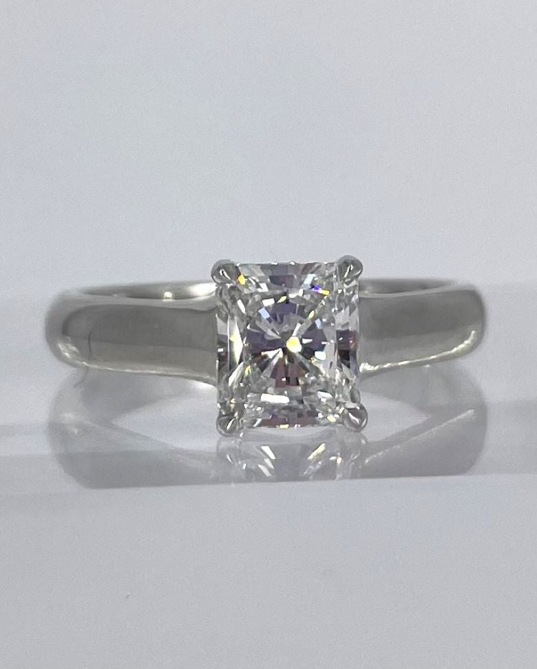 Exquisite and timeless, this solitaire diamond engagement ring by Tiffany & Co. features a 1.02 carat radiant cut diamond graded by the GIA to be F color and VS1 clarity.

Crafted in platinum, the Tiffany & Co. Lucida setting is a classic solitaire