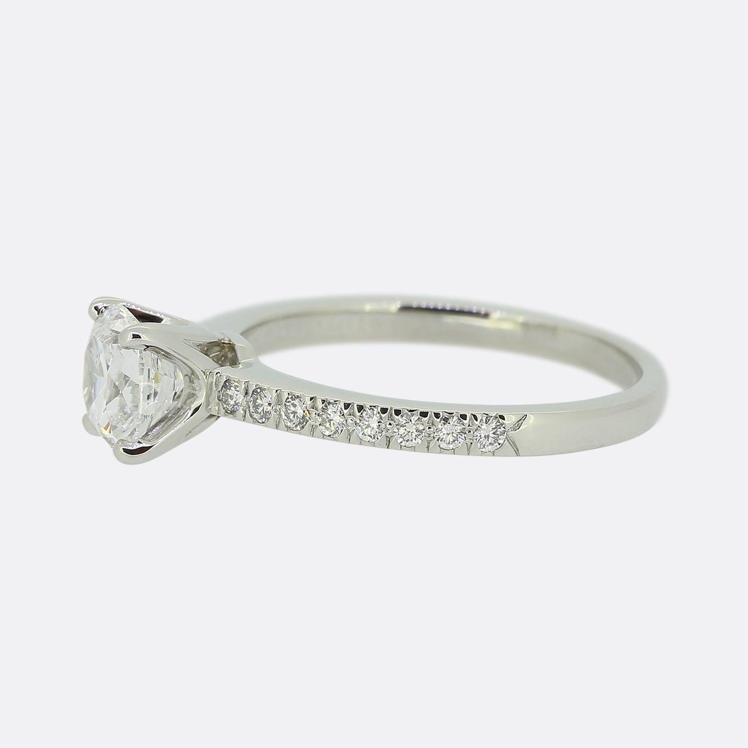 Here we have a 'Novo' diamond solitaire engagement ring from the world renowned luxury jewellery designers, Tiffany & Co. The centre stone is a 1.04 carat square cushion cut diamond which sits proud in a four clawed setting and is flanked on either