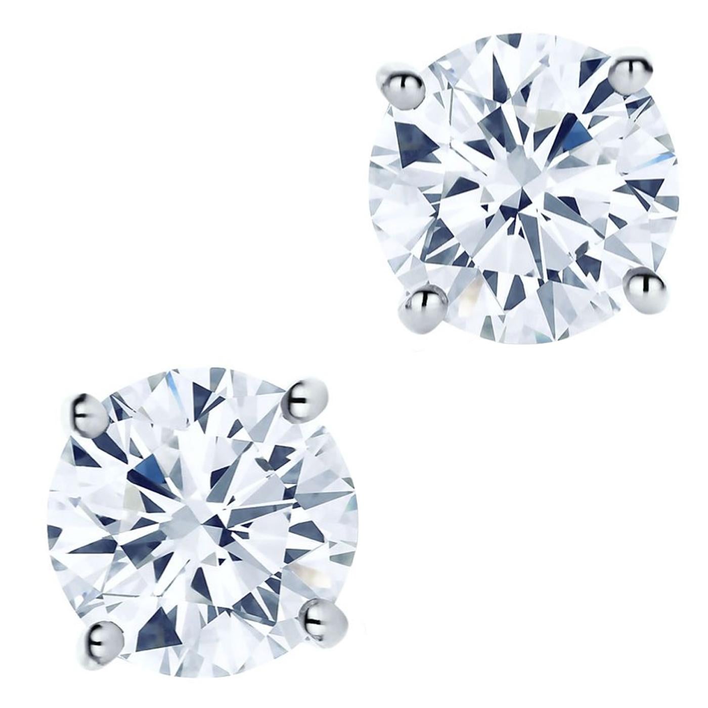 Nothing is more intriguing than Tiffany diamond earrings. 1.04 carats of beautifully matched diamonds of superlative brilliance create an undeniable presence. Round brilliant diamonds, carat total weight 1.04, color grade E, clarity grade