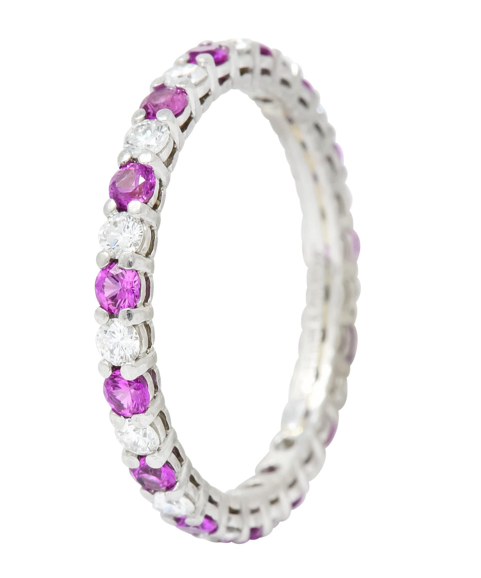 Eternity style band set with shared prongs alternating with 0.45 carat of round brilliant cut diamonds and 0.60 carat of round cut pink sapphires

Diamonds are eye-clean and white; sapphires are a bubble gum pink

Fully signed Tiffany & Co. and