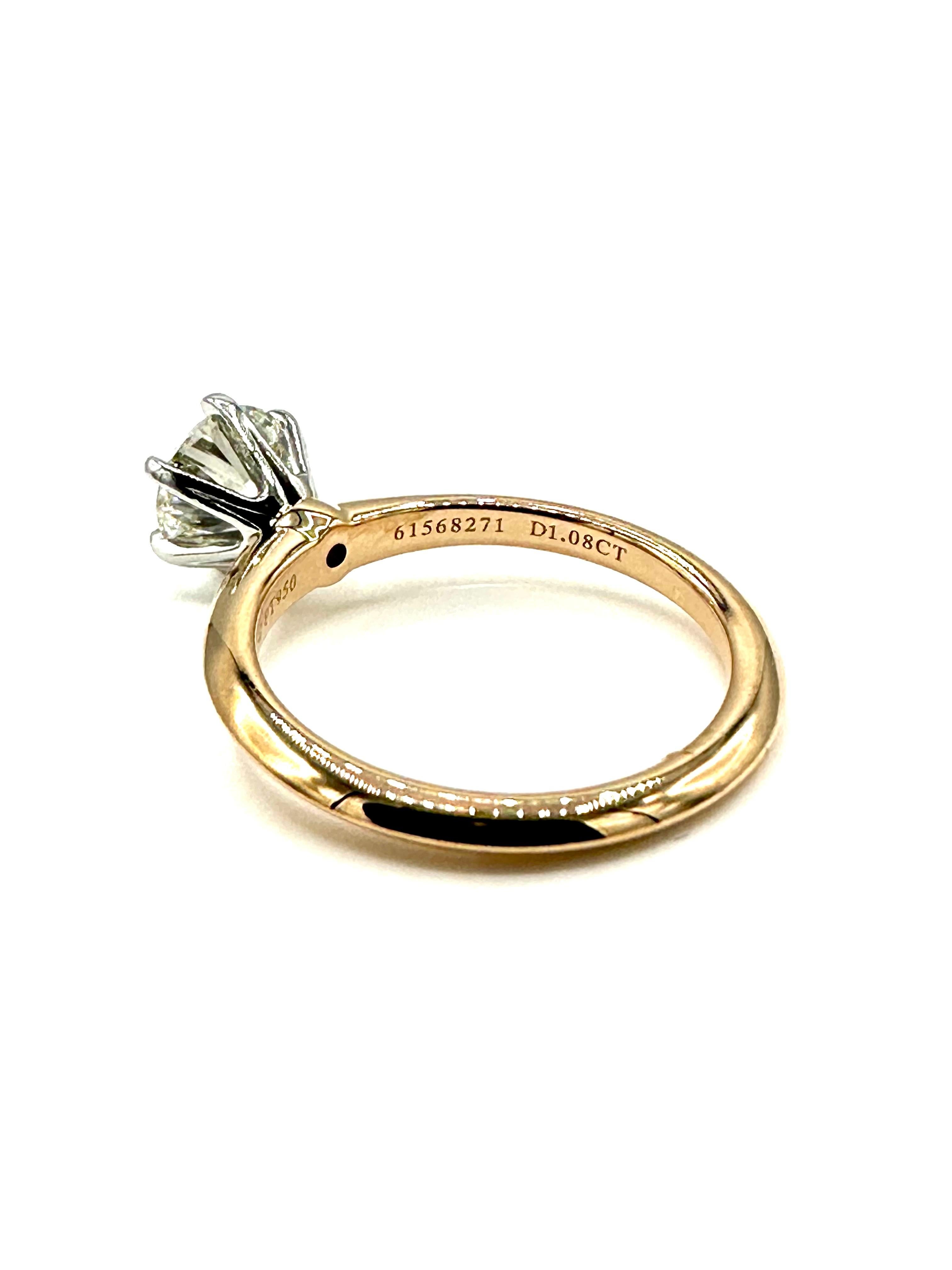 This is a stunning round brilliant Diamond engagement ring designed by Tiffany & Co.  The Diamond is set in a six prong platinum head atop a 18K yellow gold knife edge shank.  The Diamond is graded by T&Co. as I color, VVS2 clarity, with an
