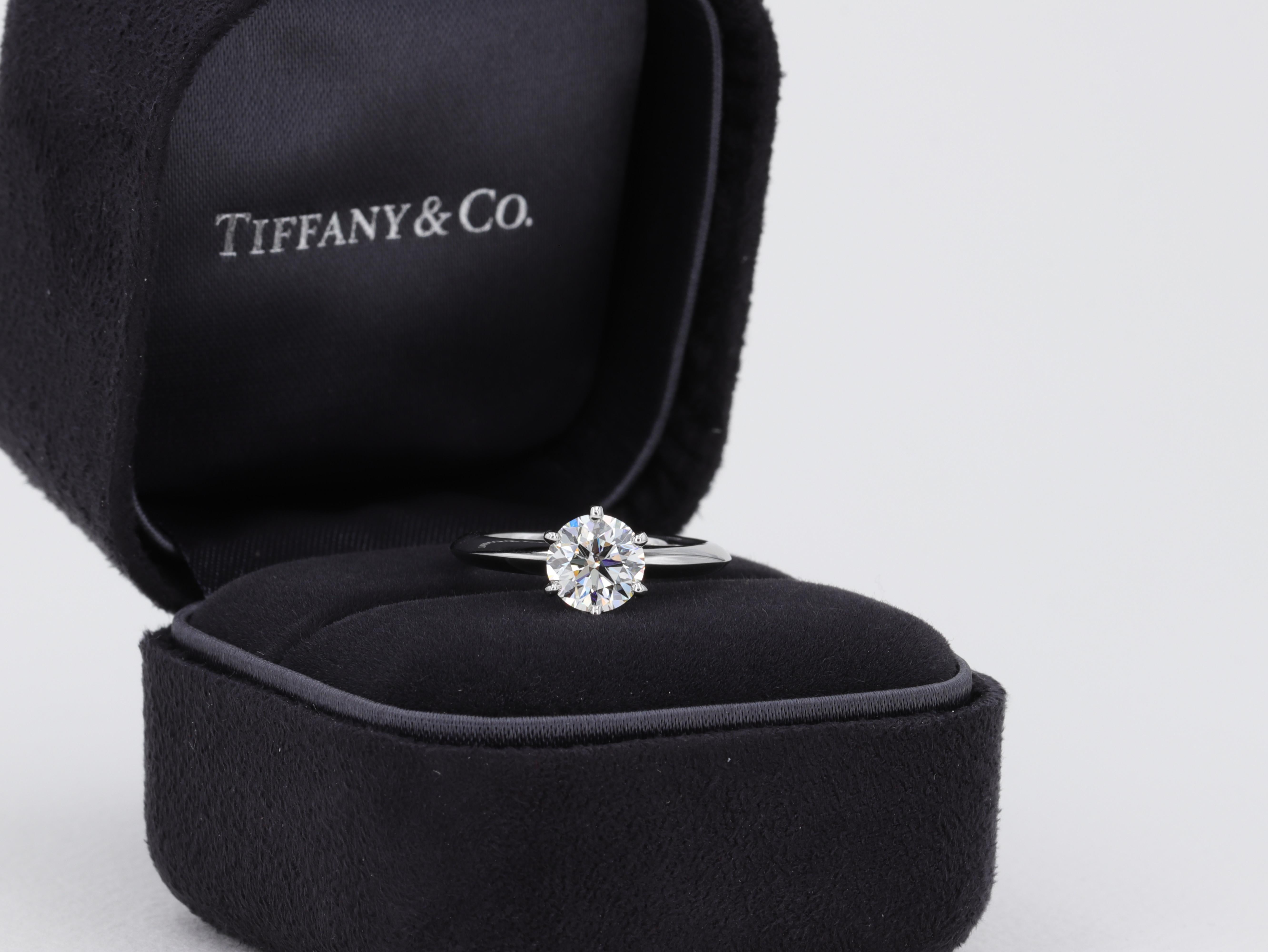 This classic Tiffany & Co. solitaire diamond engagement ring features a 1.09 carat round brilliant cut diamond graded I in color and VS1 clarity by Tiffany & Co. 

The ring is accompanied by the original inside and outside boxes, original diamond