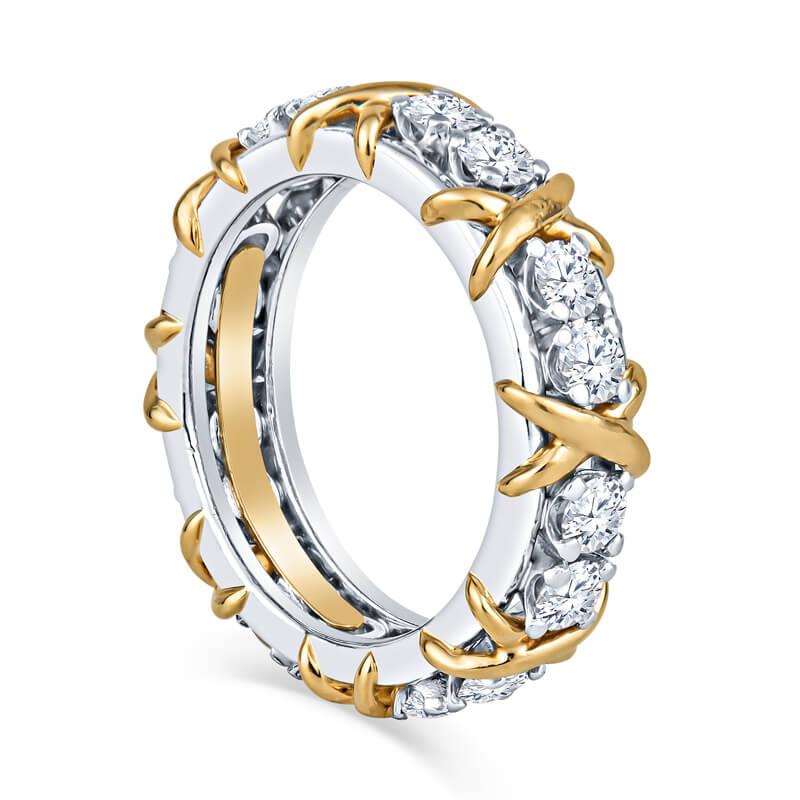 An authenticated ring from the Tiffany & Co. Schlumberger collection. This ring features 1.14 ctw of round brilliant cut diamonds that alternate with 18 karat yellow gold X's for a unique look. It is set in platinum. The ring is a size 5.
Condition: