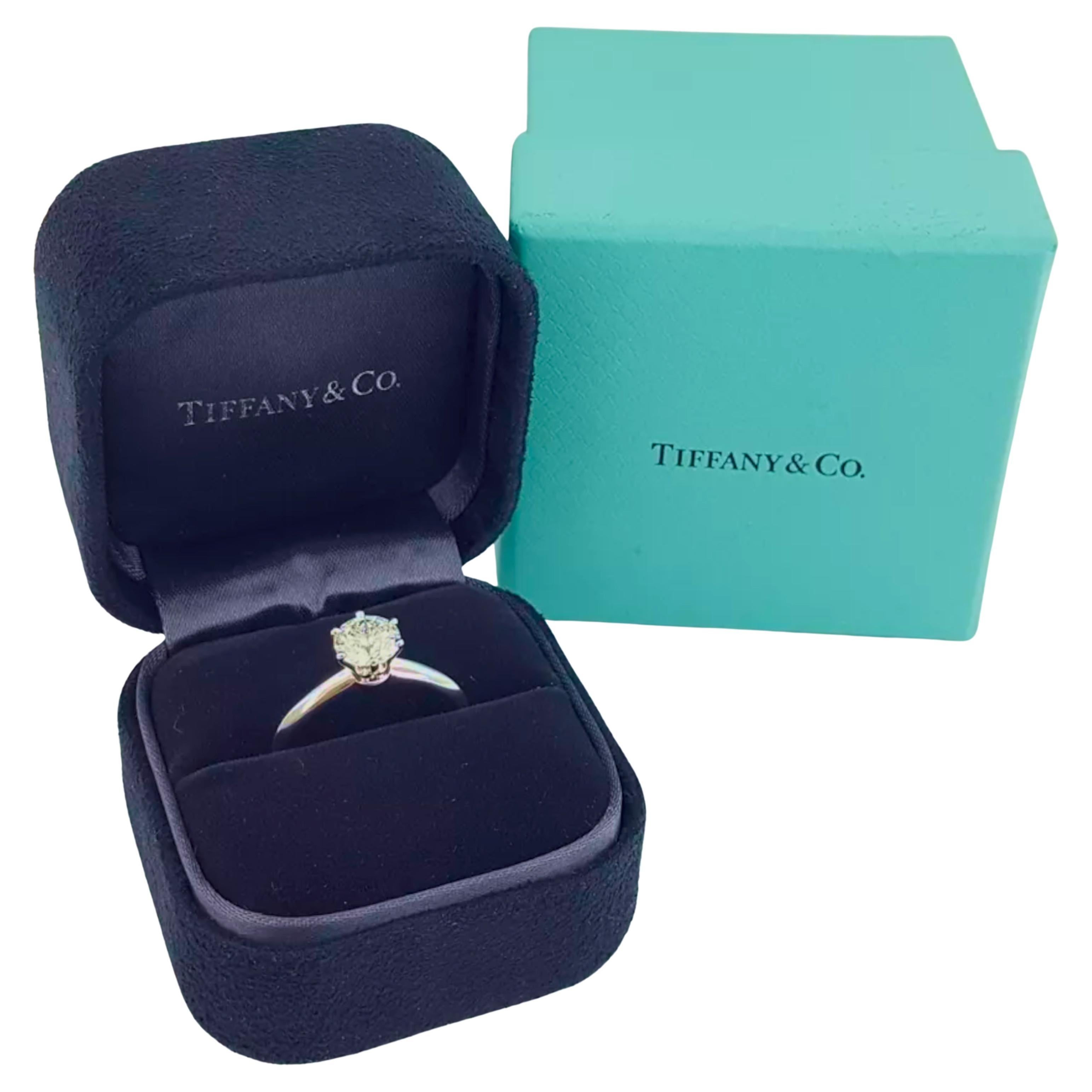  Tiffany & Co. engagement ring you described features a total diamond weight of 1.18 carats, which is notable for a solitaire design. The diamond has an H color rating, indicating it is near colorless, and a VVS2 clarity grade, meaning it has very