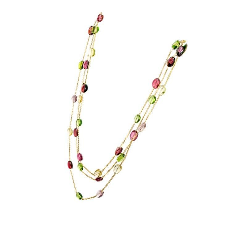 Vintage 1980's Tiffany & Co Tourmaline necklace. This spectacular necklace has 20 pink, 11 green and 9 yellow oval tourmalines. The 18k yellow gold link chain is 60 inches long and can be worn single, double or triple. 

20 pink oval double cabochon