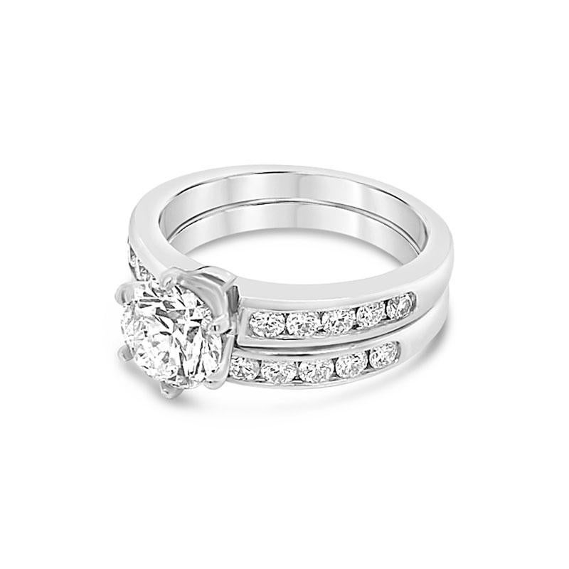 This beautiful wedding set from Tiffany & Co. features a 1.24 carat round brilliant cut diamond, G VS1, set in platinum with 0.62 carat total weight in channel set round diamonds. It is currently a size 6.5 but can be resized upon request. 
GIA