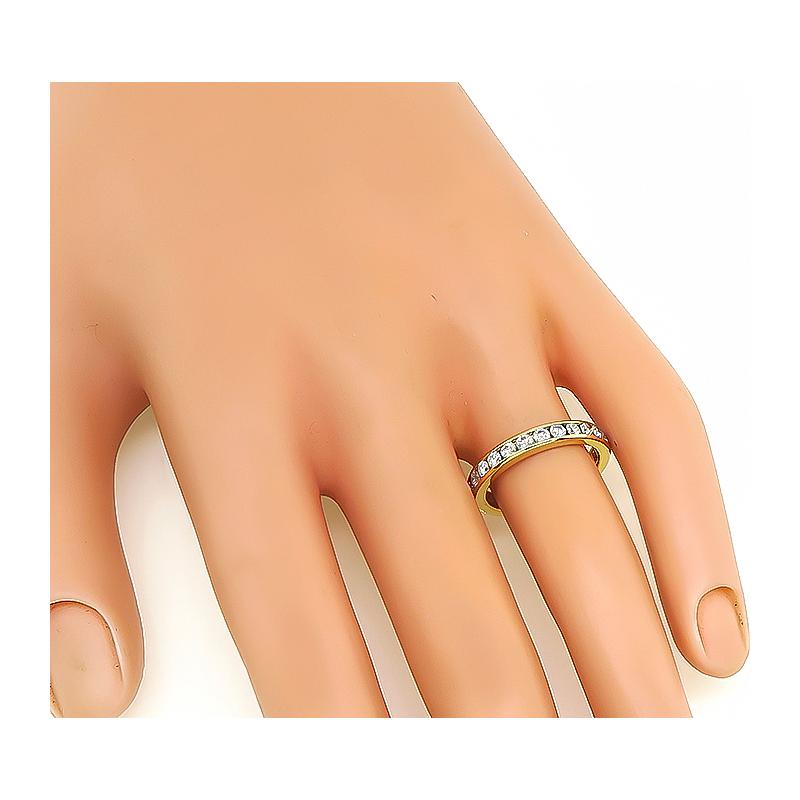 This is a charming 18k yellow gold eternity wedding band by Tiffany & Co. The band is set with sparkling round cut diamonds that weigh approximately 1.25ct. The color of these diamonds is F-G with VS clarity. The band measures 3mm in width and