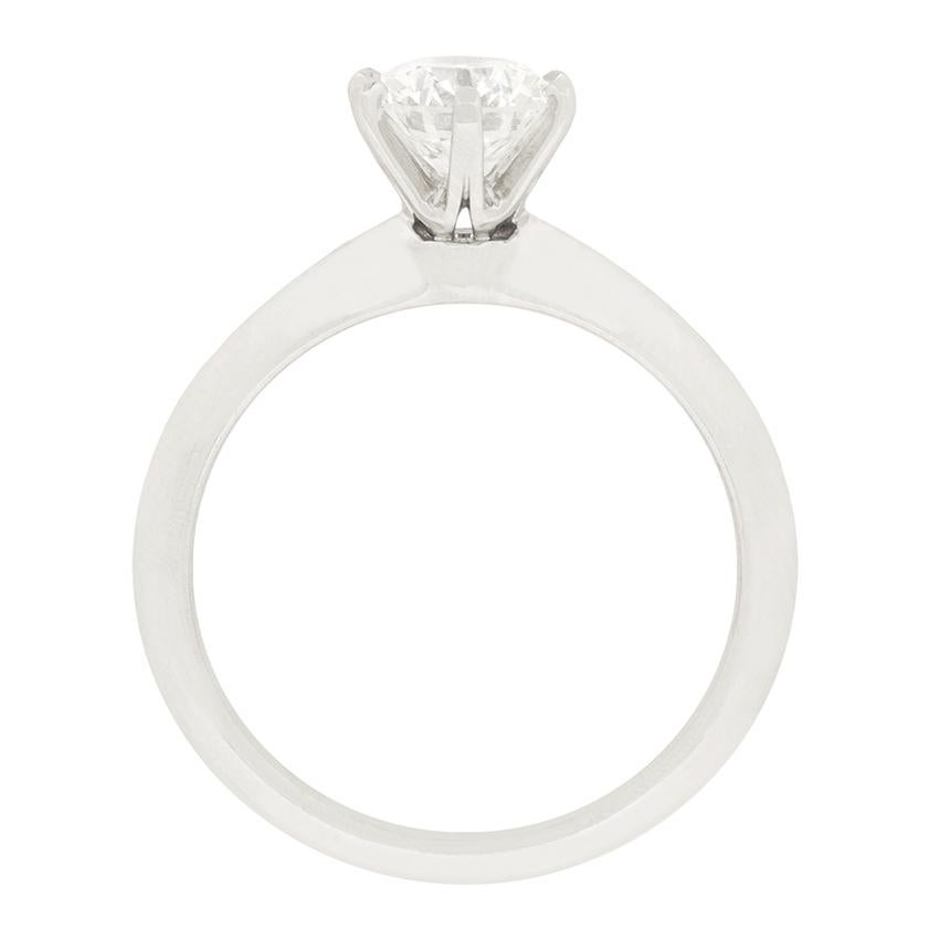 From Tiffany & Co. comes this iconic knife edge solitaire, featuring a stunning 1.25 carat round brilliant diamond. The Diamond has been graded I in colour and VS2 in clarity and is claw set within platinum. The band is crafted of the same metal