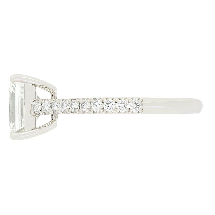 This beautiful solitaire ring comes from Tiffany & Co.'s 'Novo' Collection. At its centre sits a 1.29 carat, emerald cut diamonds. The diamond has been graded I in colour and VS1 in clarity and is expertly set into a platinum collet. Down each