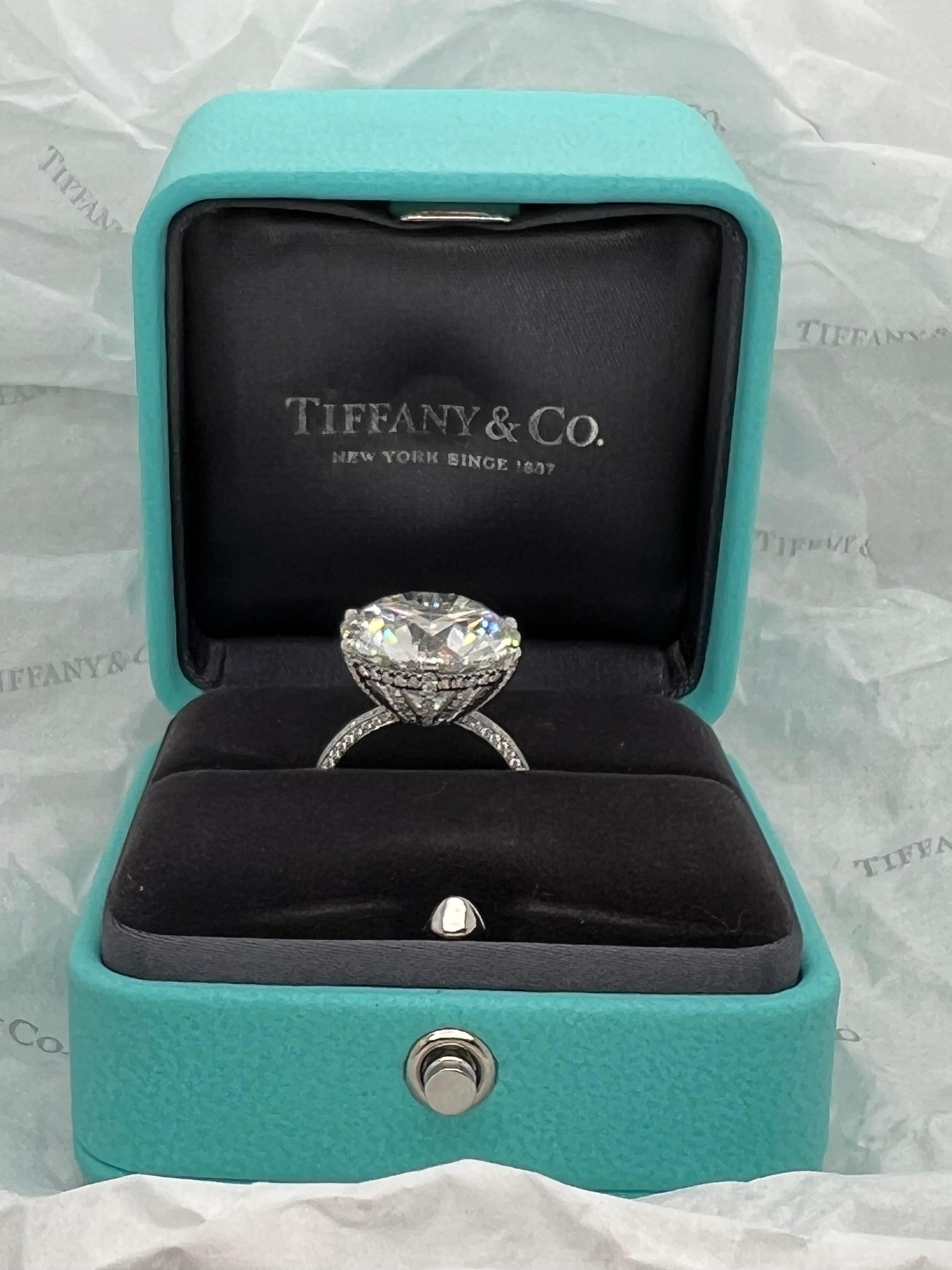 This extraordinary Tiffany & Co. platinum and diamond ring is a true work of art, featuring a stunning 13.02 carat H color VS2 clarity round brilliant cut diamond as the centerpiece. This breathtaking diamond is GIA certified, ensuring that it has