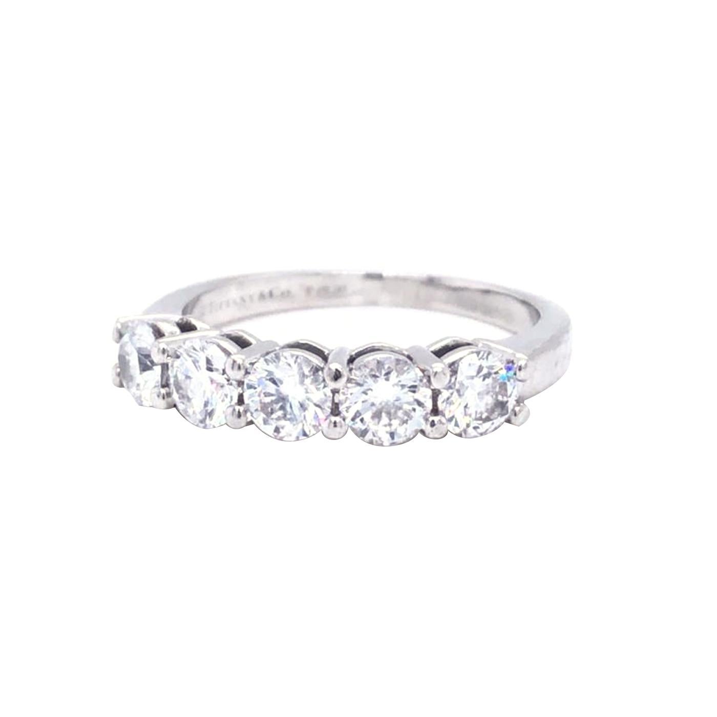 One Tiffany & co. platinum and diamond band ring, prong set with five range, VVS1 - VVS2 clarity range.

Details:
Diamond Registration Number: 63905402/T03120748
Shape: Round
Cut: Brilliant
Measurements: 4.09 - 4.12 x 2.53mm

Precision Cut: