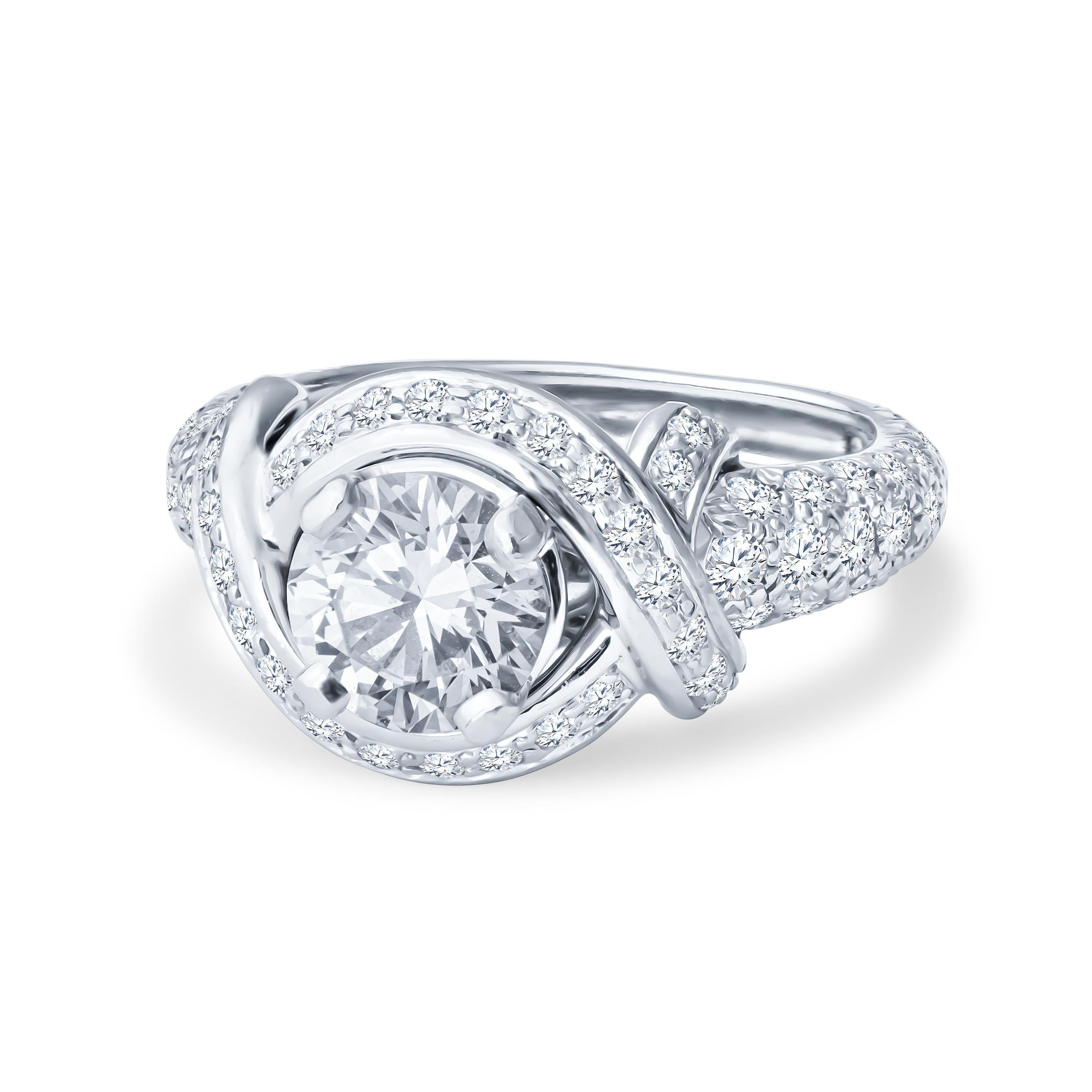 This is a Tiffany & Co. Jean Schlumberger design engagement ring. It features a 1.32ct round brilliant cut diamond of H color, VVS1 clarity, prong-set in a platinum ring alongside round brilliant cut diamonds weighing approximately 1.43ctw, D-G