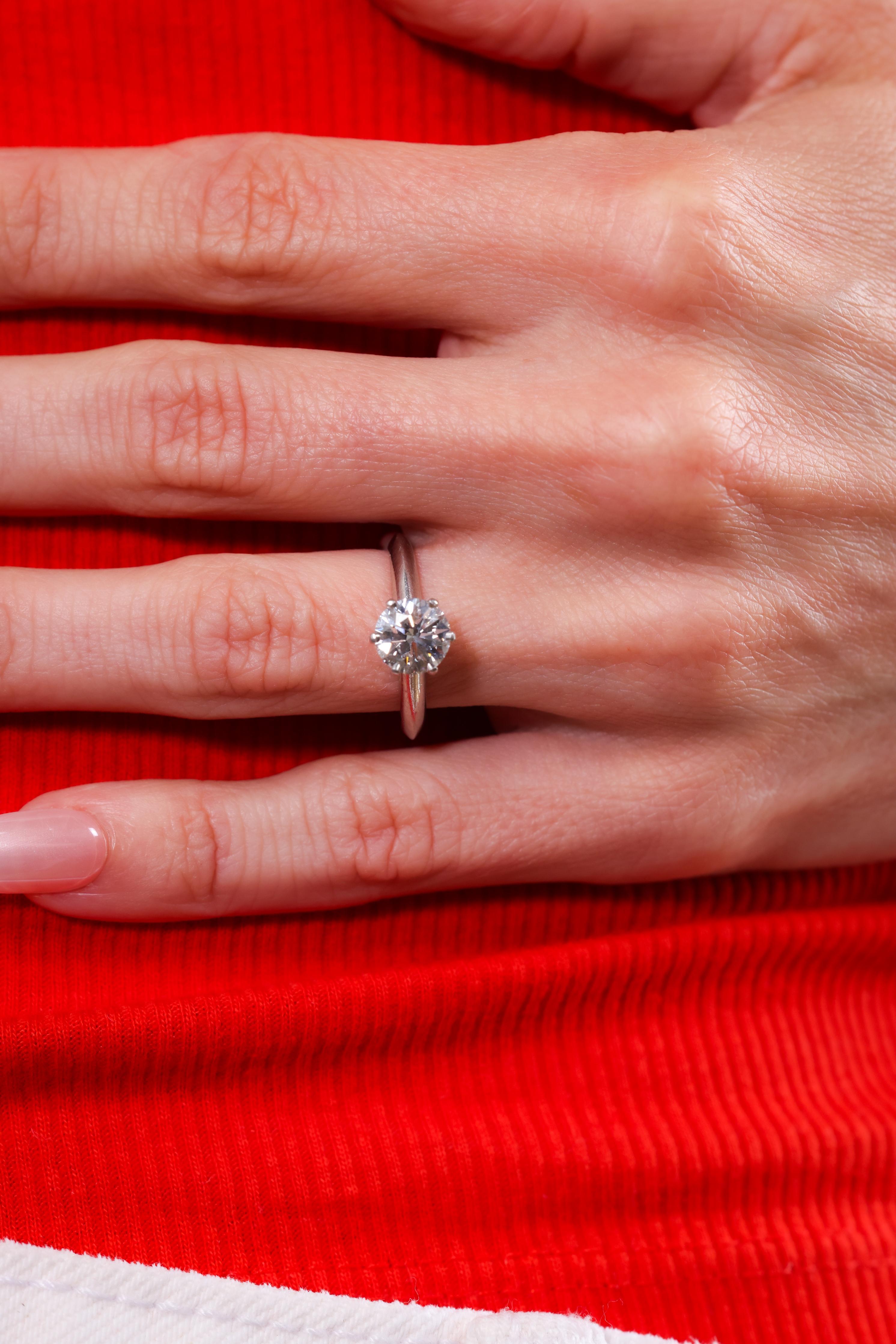Brand: Tiffany & Co.
Certificate: Tiffany 
Center Stone: Diamond
Cut: Round brilliant 
Weight: 1.34 carats
Color: G
Clarity: VS1
Metal: Platinum 
Era: Modern 
Circa: 2008
Hallmarks: Signed, numbered, weight engraved and includes original paperwork