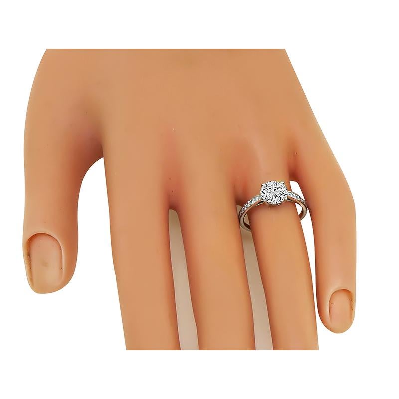 This is a stunning platinum engagement ring by Tiffany & Co. The ring is centered with sparkling round brilliant cut diamond that weighs 1.36ct. The color of the diamond is F with Internally Flawless clarity. The center diamond is accentuated by