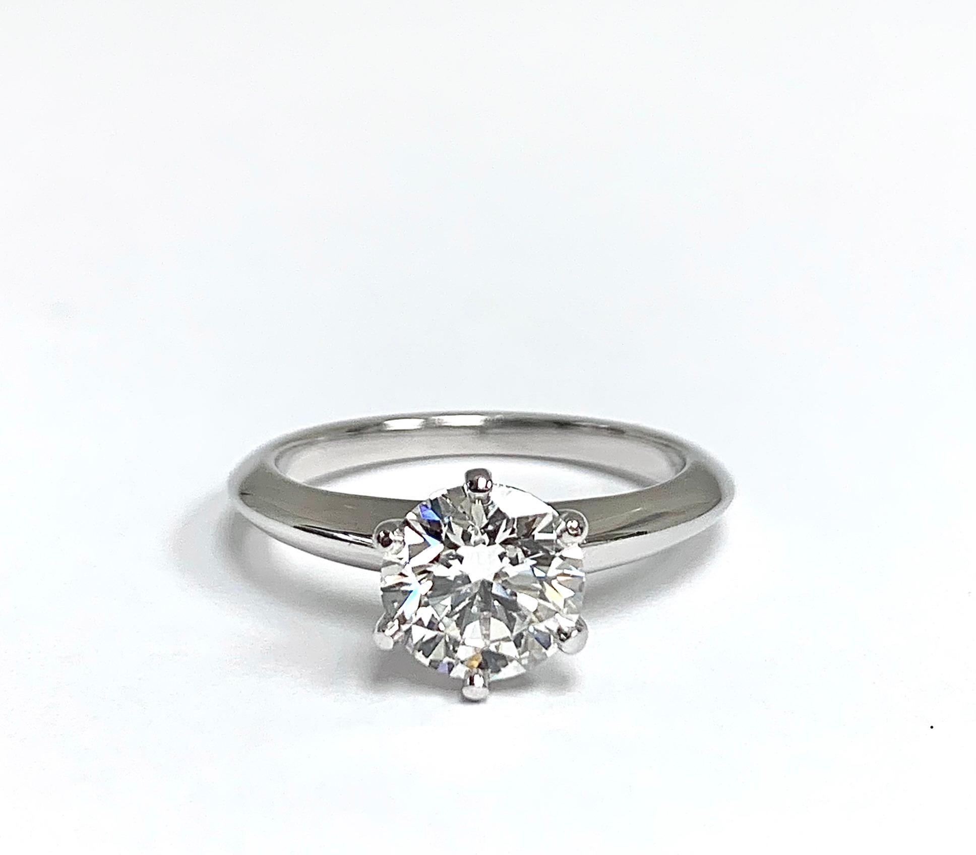 Classic Tiffany & Co Round Brilliant cut diamond set as a Solitaire Engagement Ring featuring a 1.39 ct Center graded
with a G color and Internally Flawless (IF) clarity grade, Triple Excellent Cut. Finely crafted in a 6 prong Platinum Mounting.
(