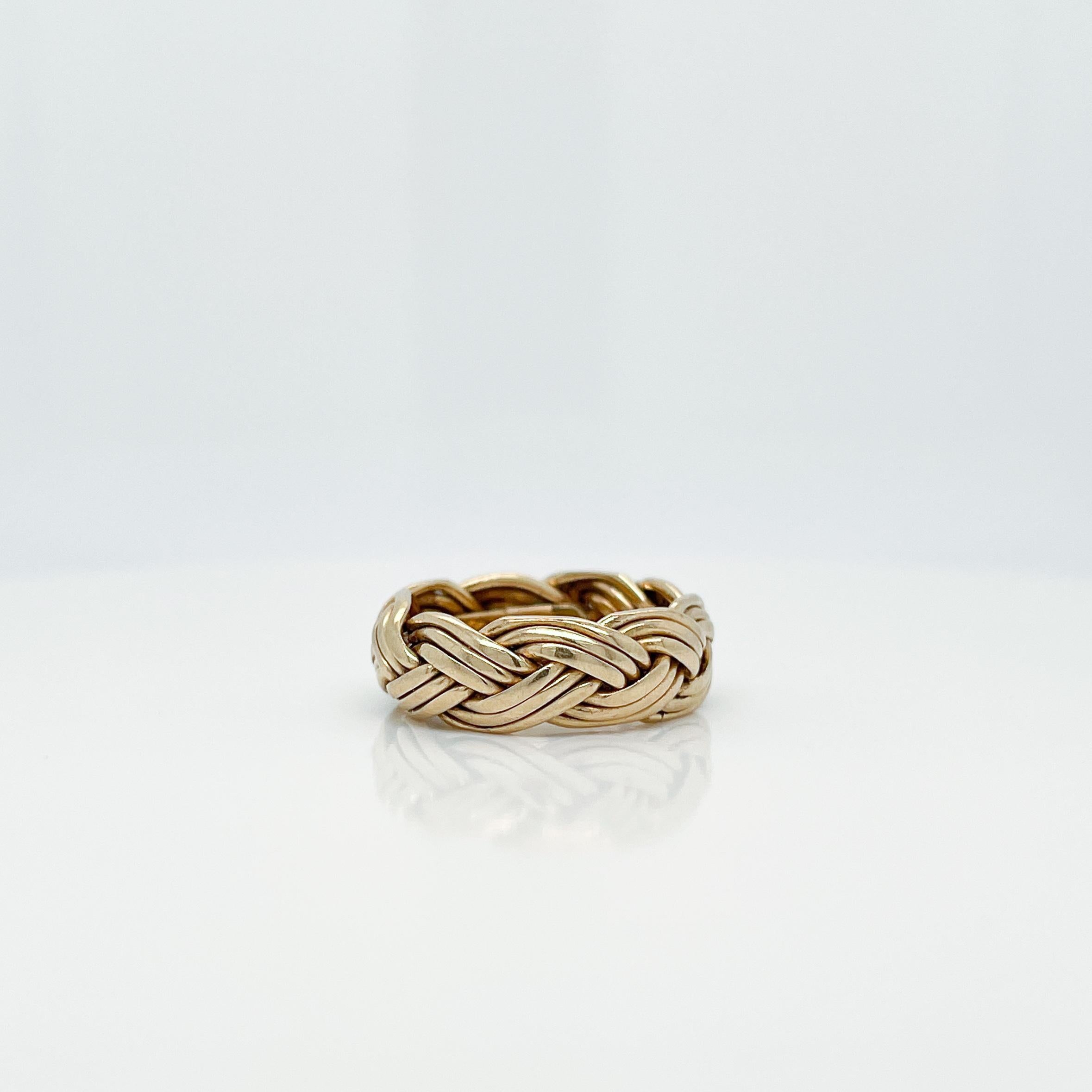 A fine braided band ring.

In 14k yellow gold.

By Tiffany & Co. 

Simply a terrific ring!

Date:
20th Century

Overall Condition:
It is in overall good, as-pictured, used estate condition.

Condition Details:
There is an added sizing band that