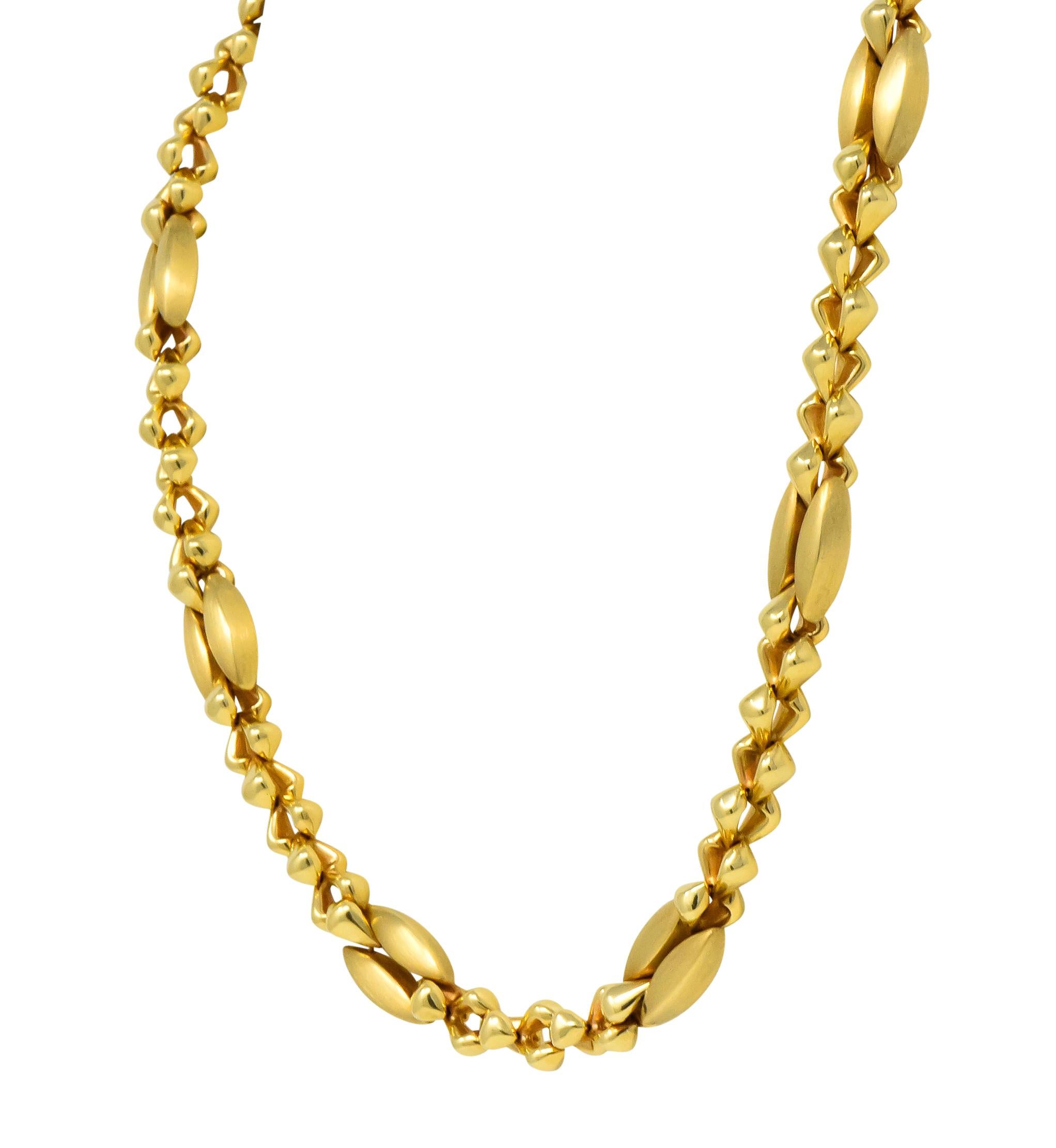 Featuring bold elongated links with matte gold finish and high polish curved triangular links

Ball clasp with push button 

Fully signed Tiffany & Co 585 (for 14 karat) with touchmark

Circa 1980

Measures: 36 inches in length, 7/16 inch at widest