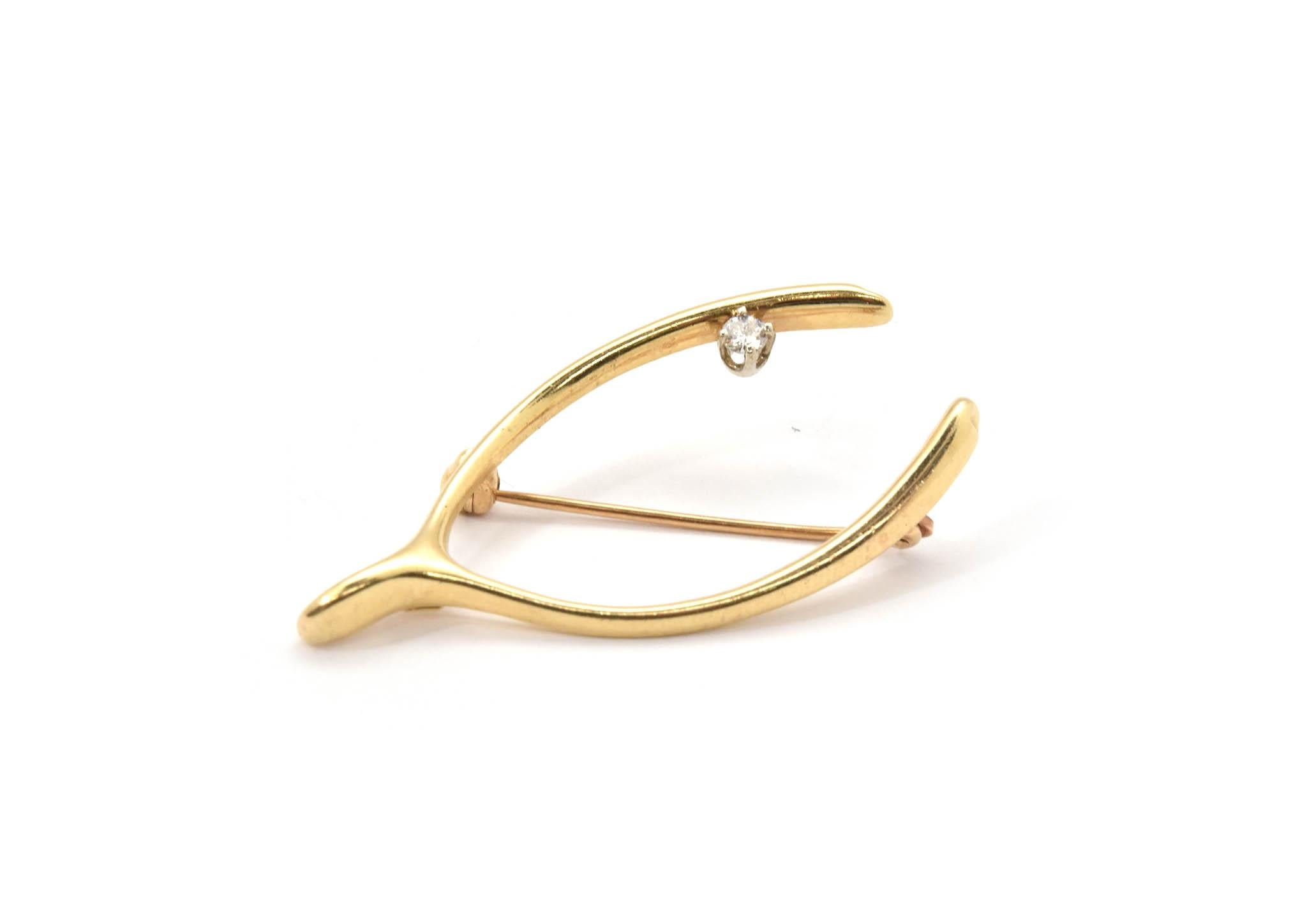 This timeless, Tiffany & Co pin is from the 1950’s and is no longer in production! The wishbone pin is made in 14k yellow gold and prong set with a 0.07ct round diamond! The Tiffany diamond quality is a G in color and VS in clarity. The pin measures