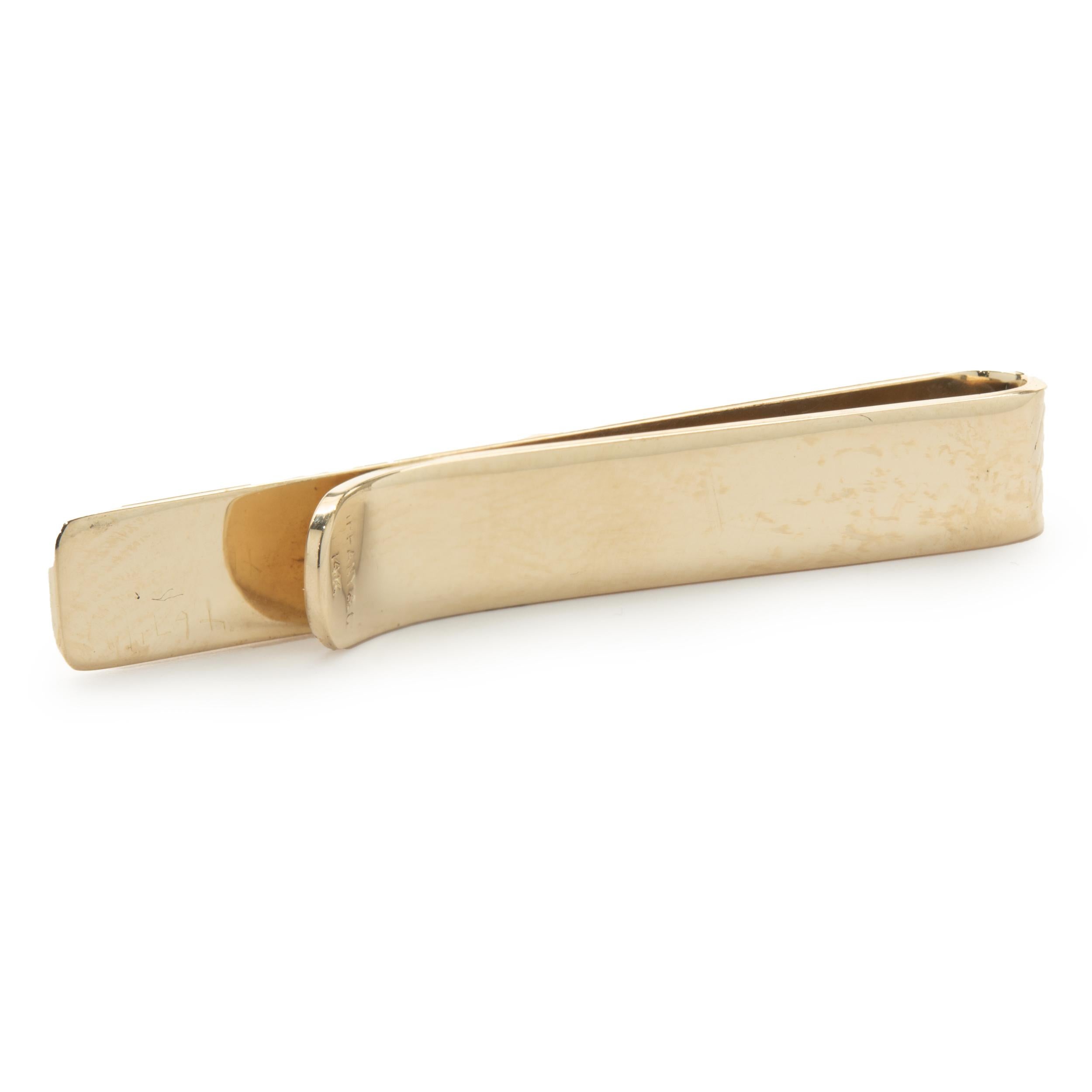 Designer: Tiffany & Co. 
Material: 14K yellow gold
Dimensions: tie bar measures 42.50 x 6.20mm
Weight: 5.99 grams
