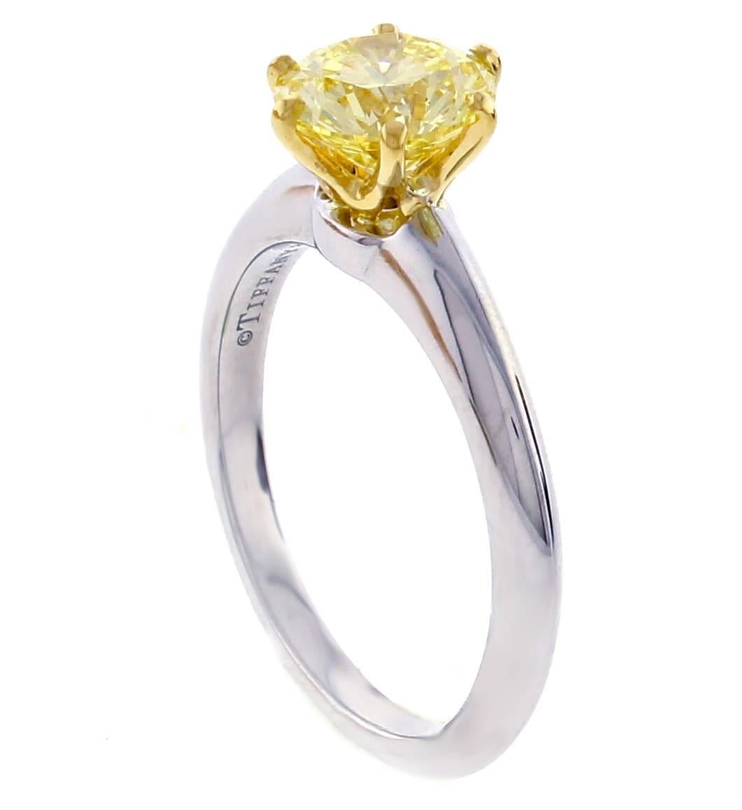 From Tiffany & Co., the world’s most iconic engagement ring.  The brilliant fanny yellow diamond shines like the sun in this platinum and 18 karat setting. Diamond weighs 1.44,  FY color and VS1 clarity. Size 6   GIA report