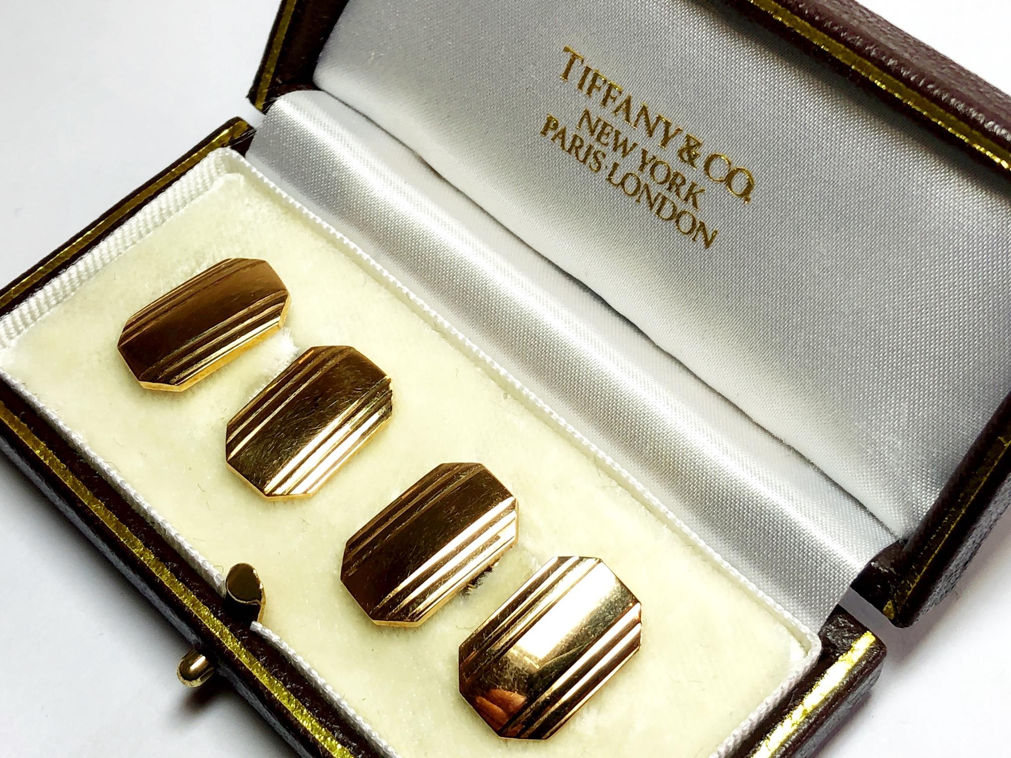 A pair of Tiffany & Co. 14ct gold cufflinks, with a cut cornered rectangle design, with engraved stripes, on  bar links. Marked 14k signed Tiffany circa 1975.