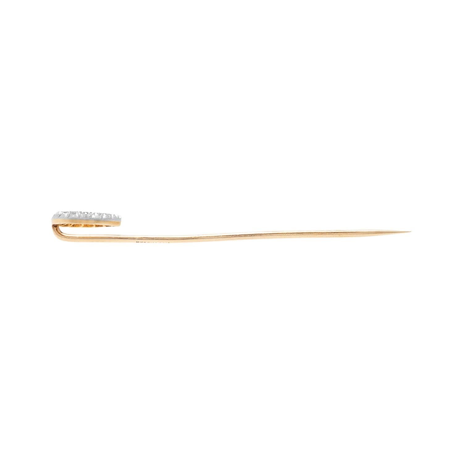 A beautiful vintage TIFFANY & CO horseshoe stick pin (ca1940)! The pin is crafted in 14kt yellow and white gold and features a delicate diamond horseshoe. The horseshoe holds 15 small graduated round cut diamonds. Attached to the back of the