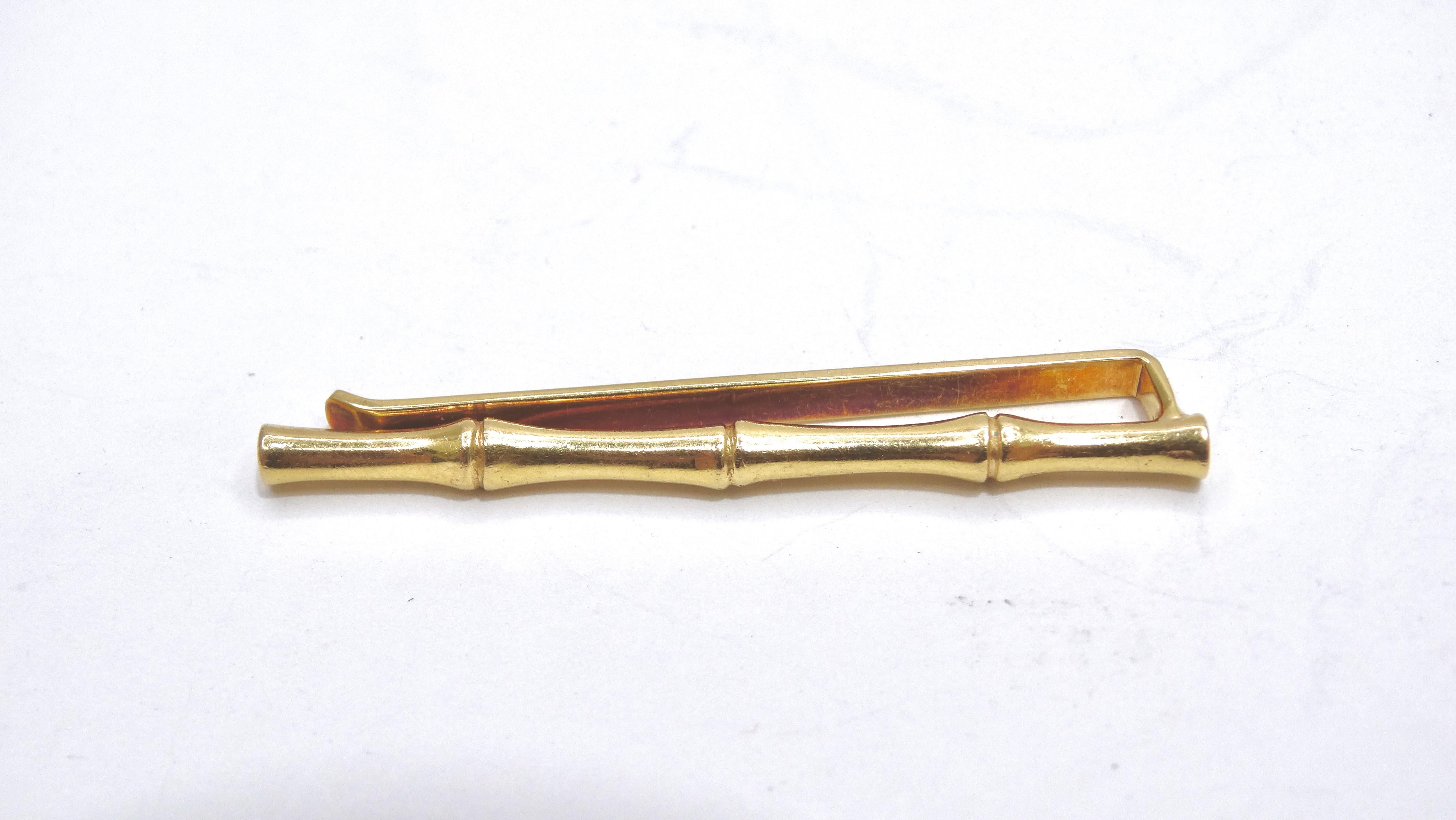 Accessorize your next vacation formal wear this this 14k gold bamboo tie clip. Everyone knows it's all in the details. Pair this with a Giorgio Armani dress shirt, smart linen trousers, and a linen blazer. Signed 'TIFFANY & CO'. Can be used as a