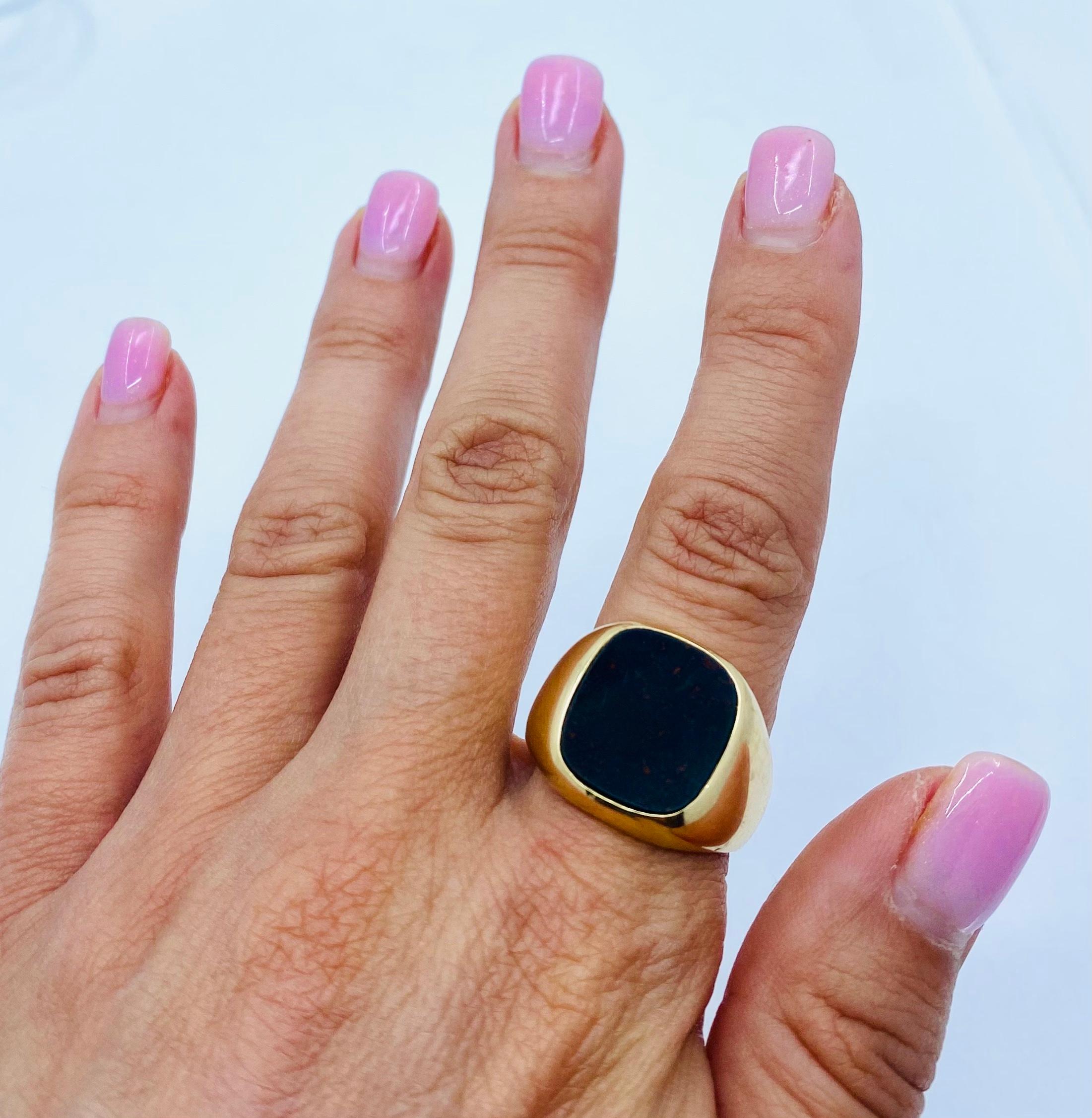 Designer: Tiffany & Co.
Materials: 14 karat Yellow Gold
Weight: 17.1 grams
Gemstone:  Bloodstone
Ring Size: 10.5
Hallmarks: Tiffany, 14K

A Tiffany & Co. 14k gold signet ring features bloodstone. It’s a classic gold Tiffany signet ring, bold and