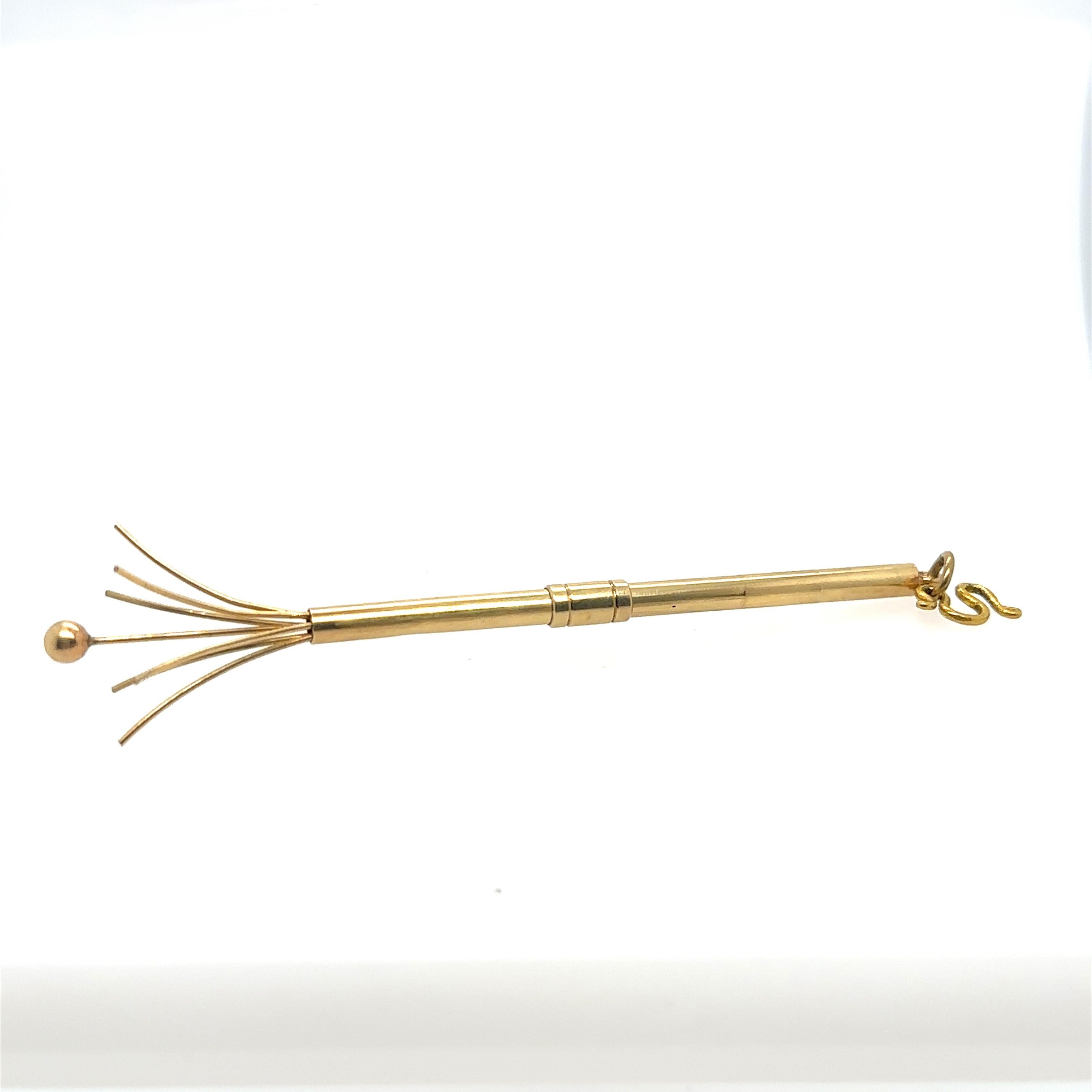 A unique addition to any collection. A Tiffany & Co. 14k yellow gold swizzle stick with black leather holder. 
Total weight: 5.6 grams.
