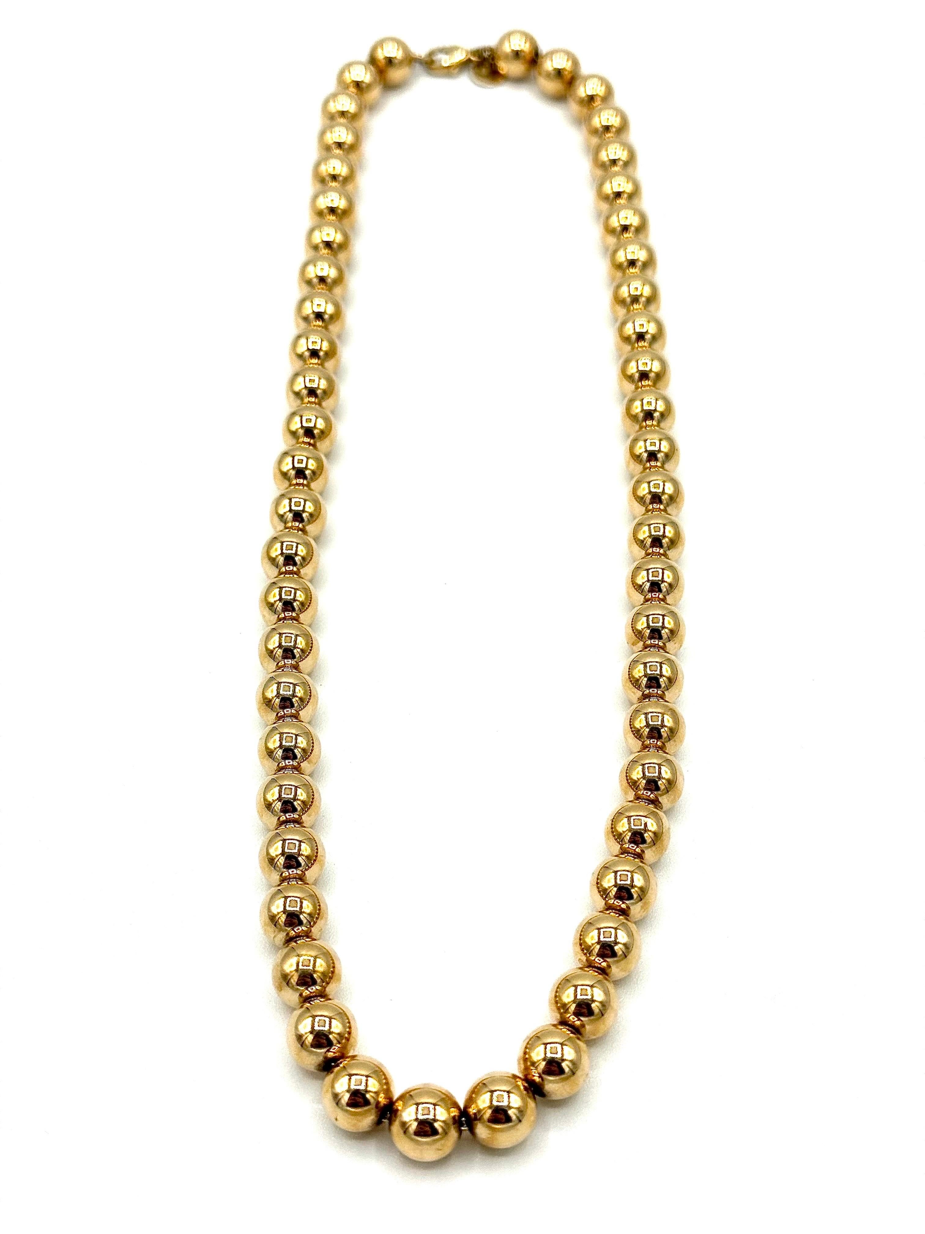 A perfect for every occasion Tiffany & Co. gold necklace.  The necklace is designed with 8.20mm 14K yellow gold ball beads all the way around on a 14K yellow gold chain with a lobster claw clasp.  It is 18 inches in length and has a tag next to the