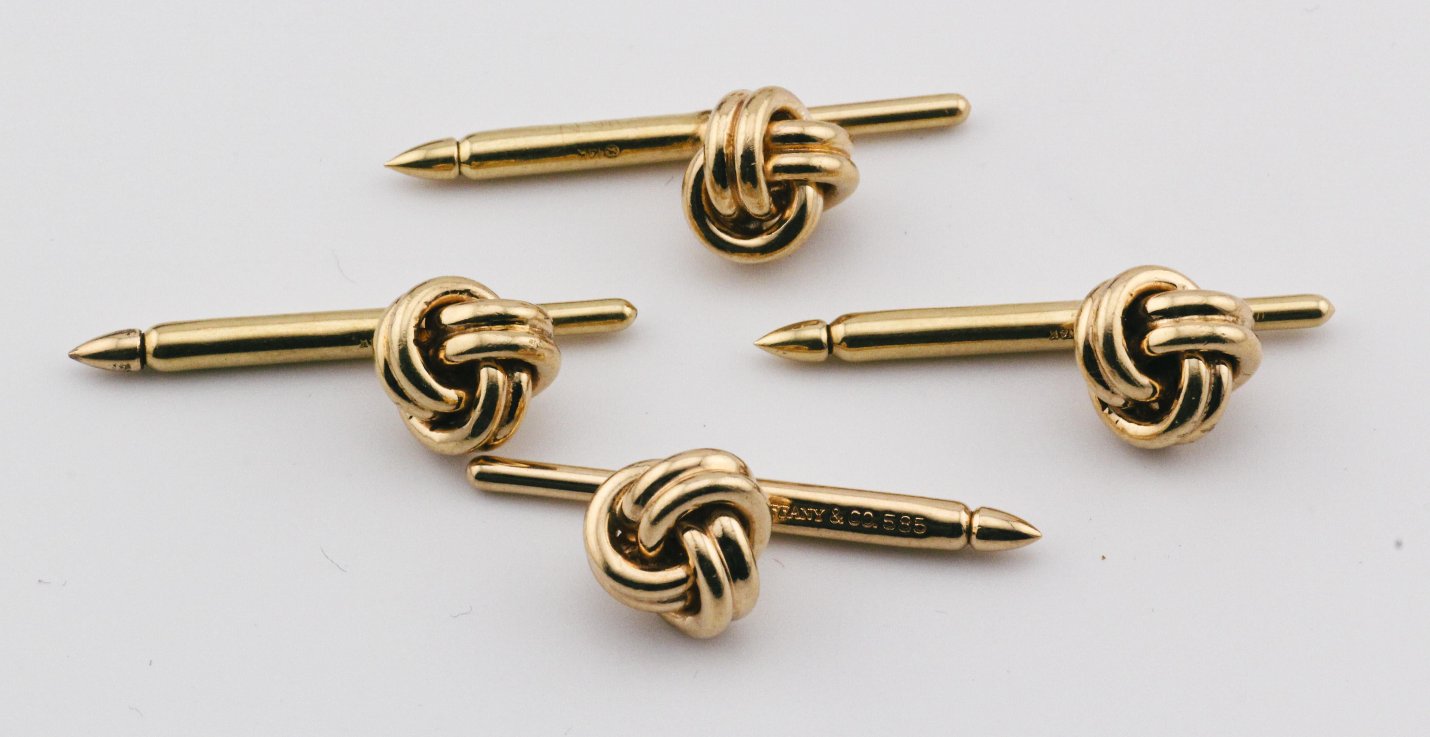 Indulge in the epitome of sophistication and refinement with the Tiffany & Co. 14K Yellow Gold Knot Cufflinks and 4 Studs Set. Crafted with the utmost precision and elegance, this exquisite set exemplifies Tiffany's legacy of luxury and timeless